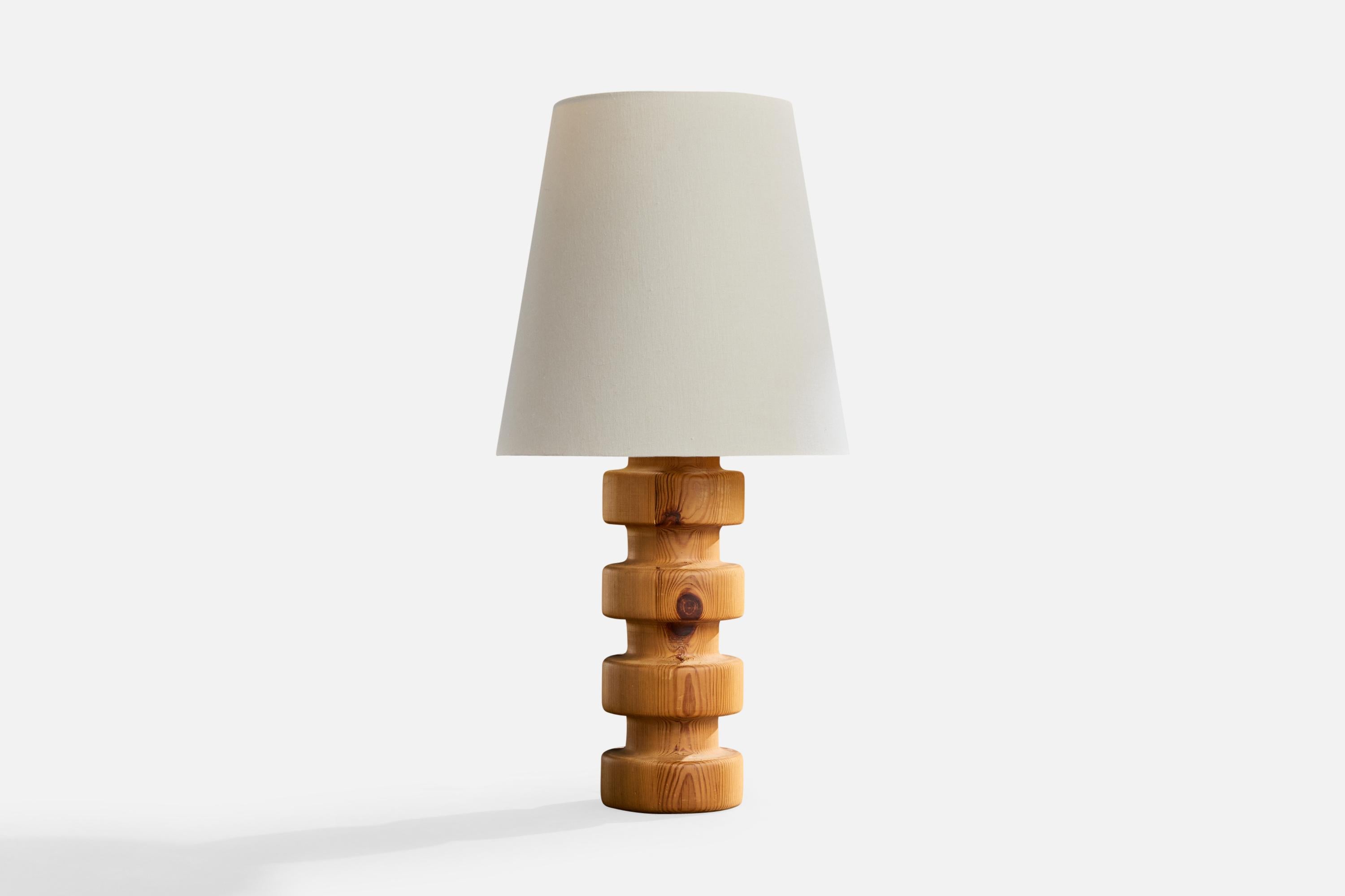 A pine and white fabric table lamp designed and produced in Sweden, c. 1970s.

Dimensions of Lamp with Shade (inches): 26.5