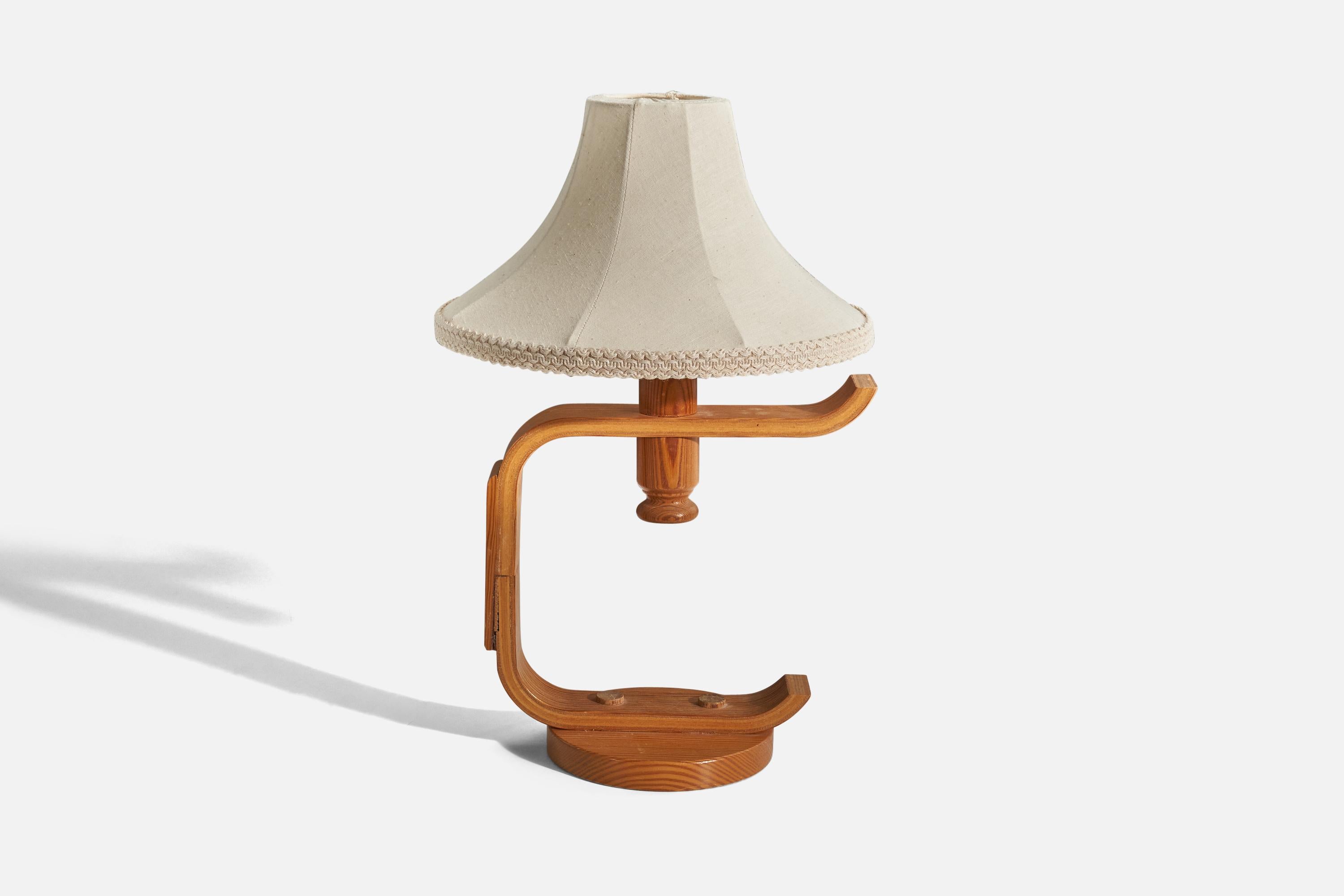 A pine table lamp designed and produced in Sweden, c. 1970s.

Sold with fabric lampshade. 
Dimensions stated refer to the table lamp with the lampshade.