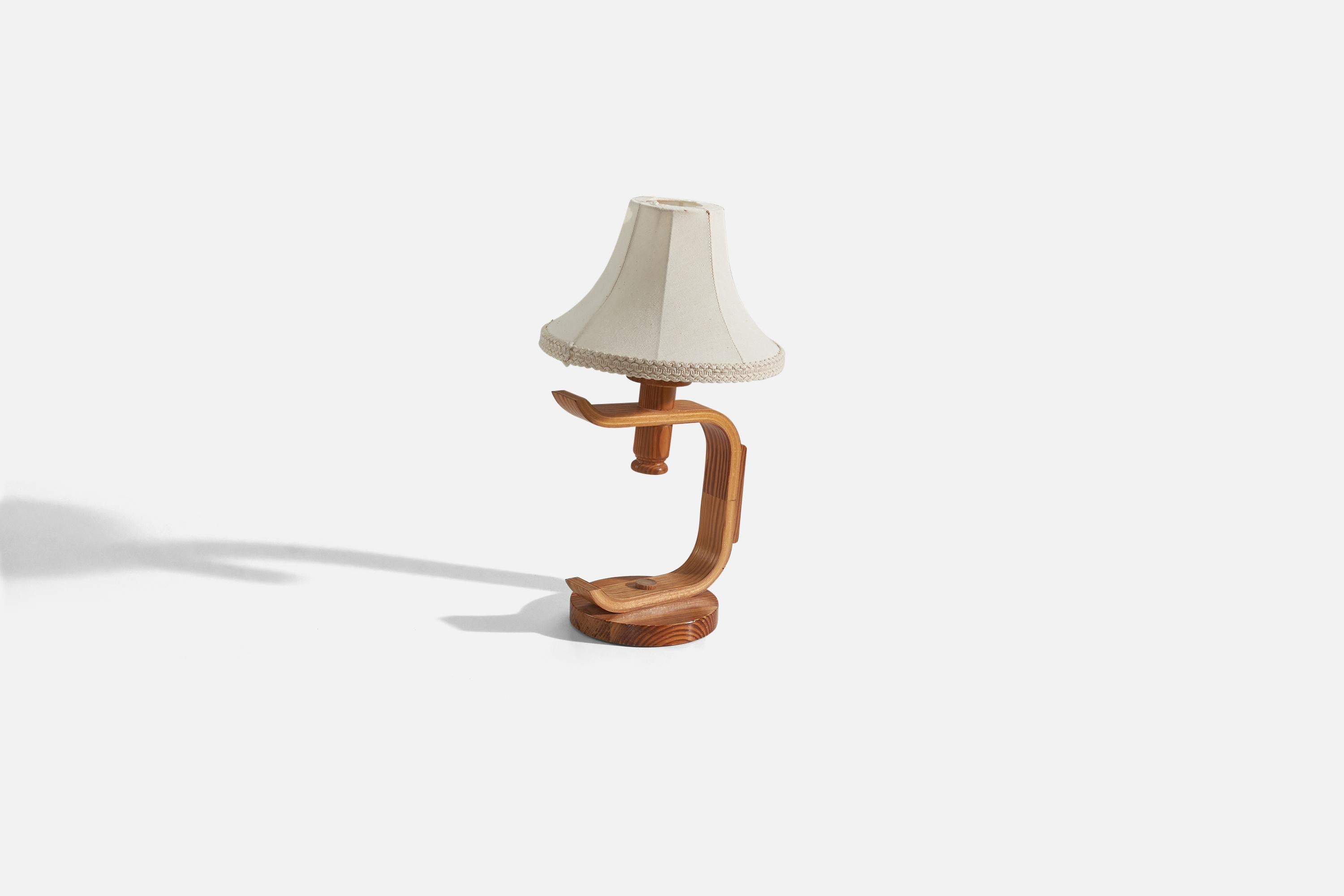 A pine table lamp designed and produced in Sweden, c. 1970s.

Sold with fabric lampshade. 
Stated dimensions refer to the table lamp with the lampshade.