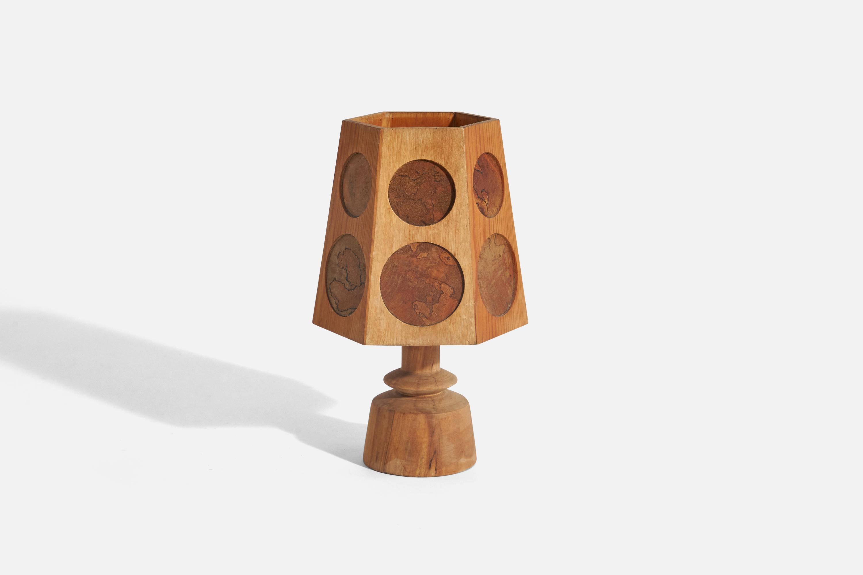 A pine and masur birch table lamp designed and produced in Sweden, 1970s.

Socket takes E-14 bulb.
There is no maximum wattage stated on the fixture.