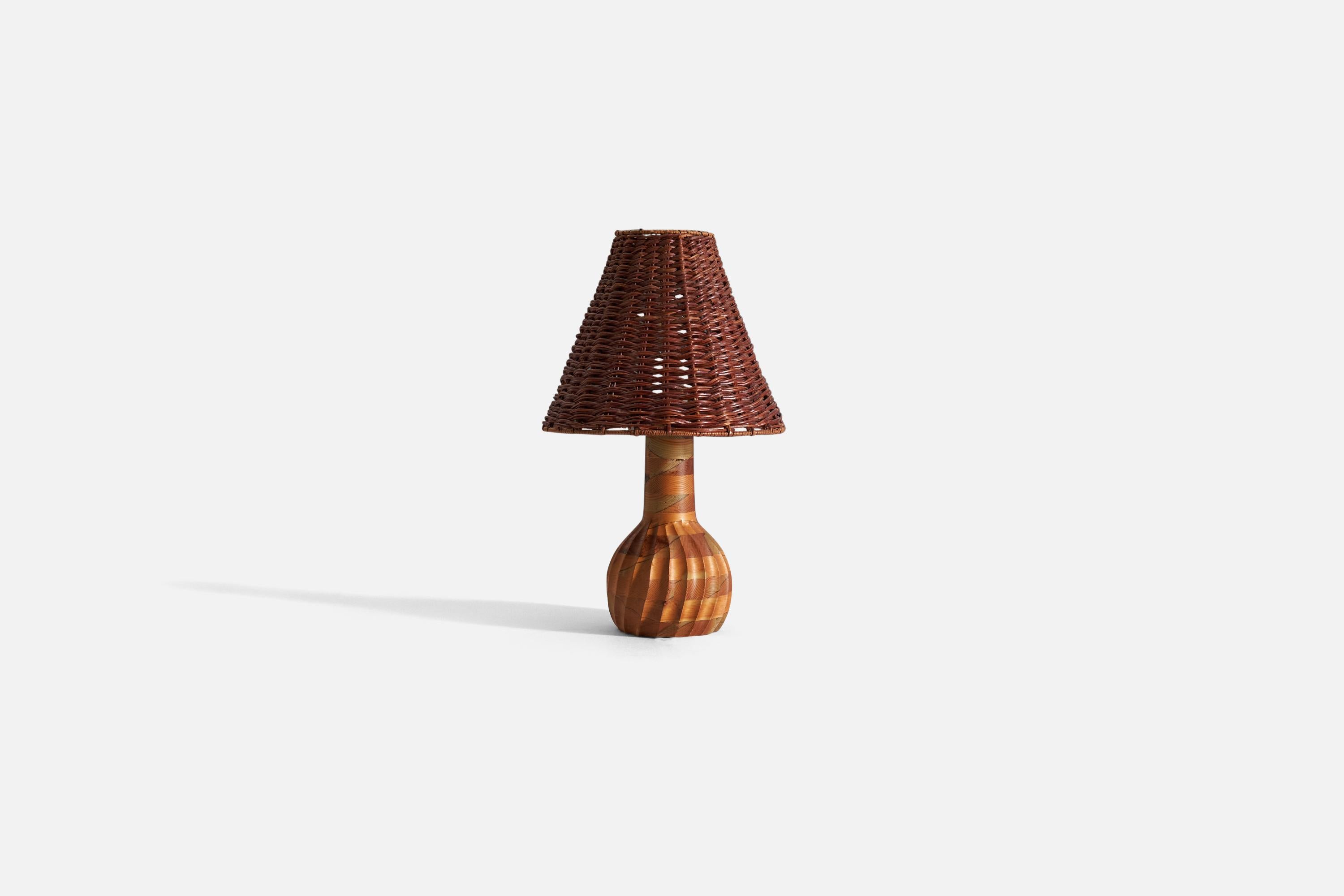 A table lamp, designed and produced in Sweden, c. 1970s. In stack-laminated pine. 

Stated dimensions exclude lampshade. Illustrated lampshade can be included upon request.

Dimensions of lamp with shade H 16.9” / W 10”.
Dimensions of shade-
