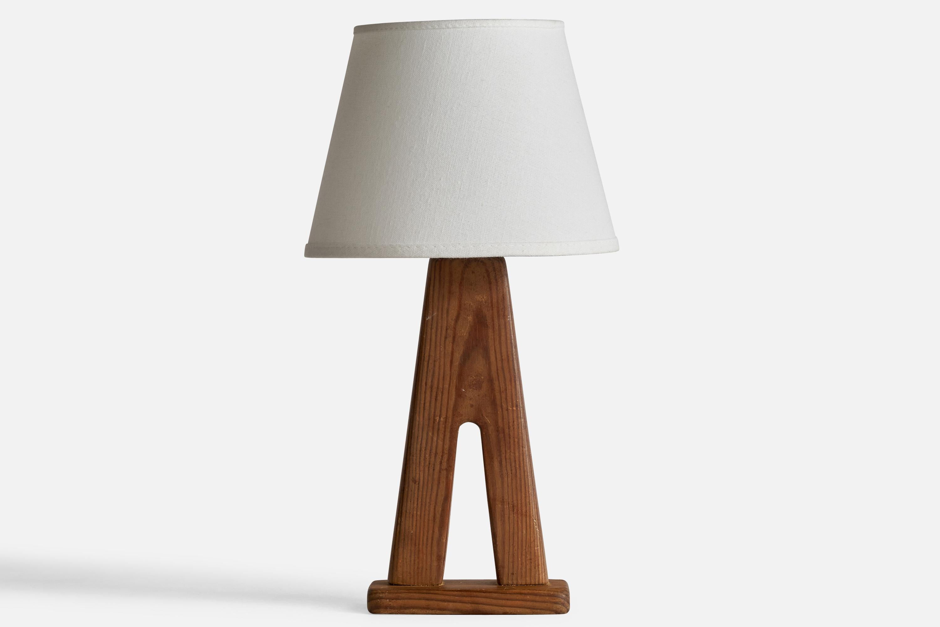 A pine table lamp designed and produced in Sweden, 1950s.

Please note cord feeds from socket exposing cord running along base.

Dimensions of Lamp: 11.55” H x 5” W x 3.1” D
Dimensions of Shade (inches): 5” Top Diameter x 8” Bottom Diameter x 6”
