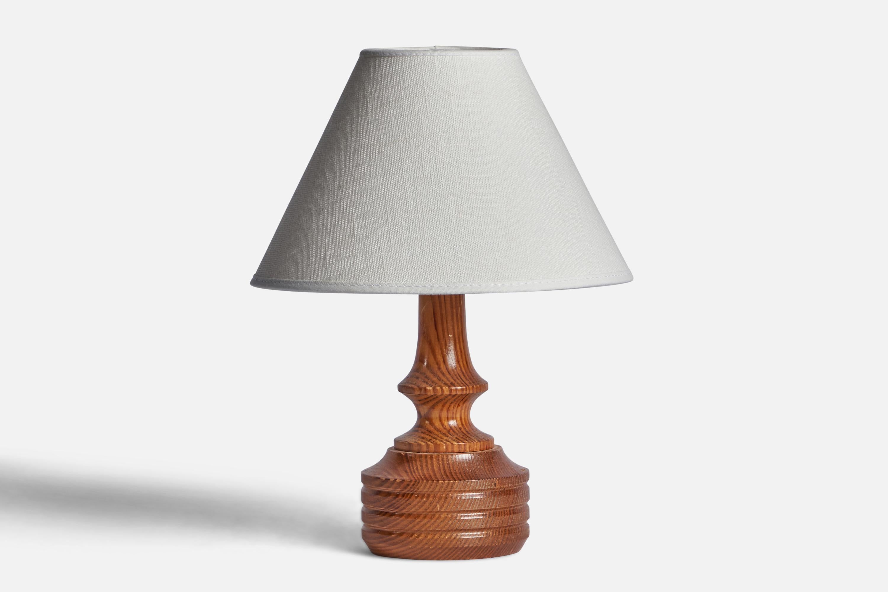 A pine table lamp designed and produced in Sweden, 1960s.

Dimensions of Lamp (inches): 7.85” H x 3.65” Diameter
Dimensions of Shade (inches): 3” Top Diameter x 8” Bottom Diameter x 5” H 
Dimensions of Lamp with Shade (inches): 10.85” H x 8”