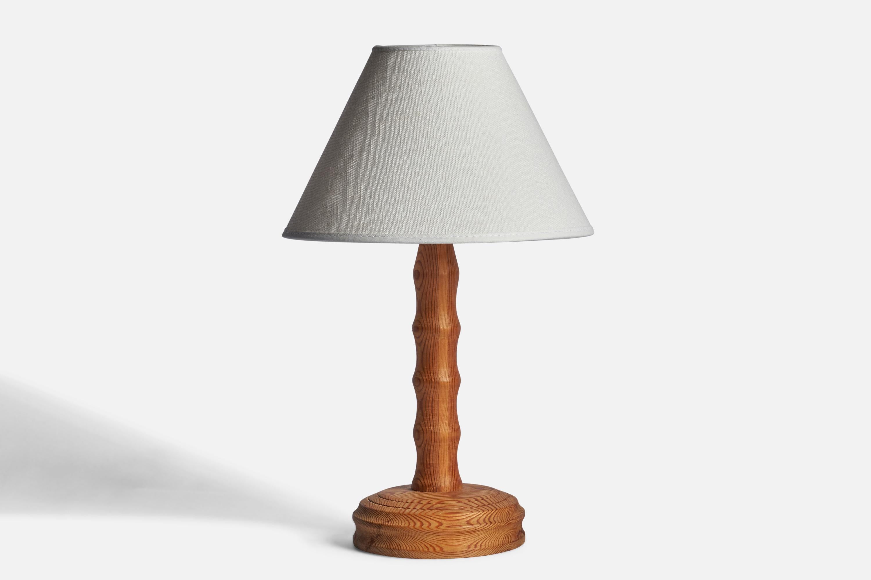 A pine table lamp designed and produced in Sweden, c. 1960s.

Dimensions of Lamp (inches): 10.15” H x 4.5” Diameter
Dimensions of Shade (inches): 3” Top Diameter x 8” Bottom Diameter x 5” H 
Dimensions of Lamp with Shade (inches): 13” H x 8”