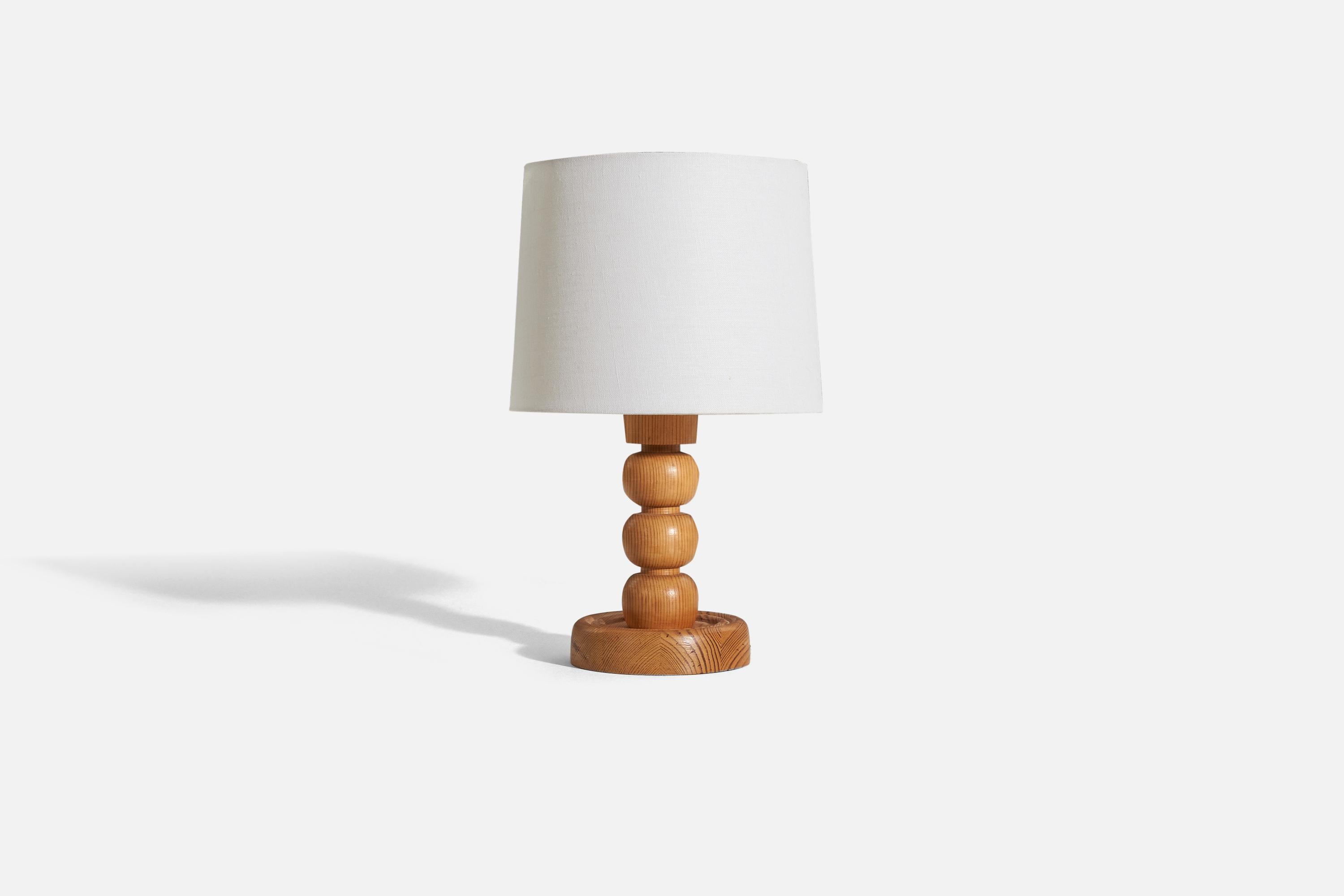 A solid pine table lamp designed and produced by a Swedish designer, Sweden, 1970s.

Sold without lampshade. 
Dimensions of Lamp (inches) : 11.25 x 5.875 x 5.875 (H x W x D)
Dimensions of Shade (inches) : 9.125 x 10 x 7.875 (T x B x H)
Dimension of