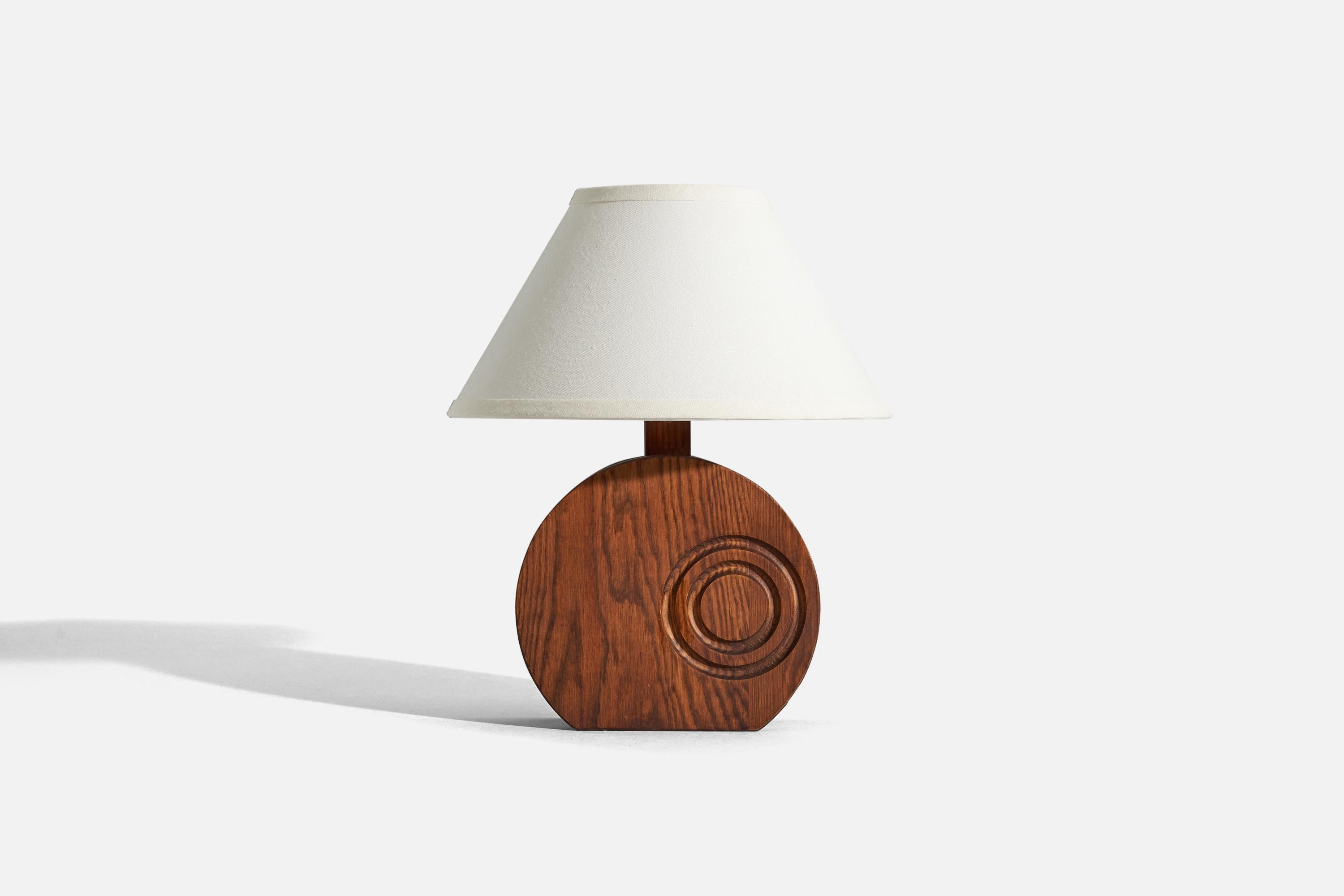 A pine table lamp designed and produced by a Swedish designer, Sweden, c. 1970s.

Sold without lampshade. 
Dimensions of Lamp (inches) : 11.875 x 8.25 x 2.75 (H x W x D)
Dimensions of Shade (inches) : 5.25 x 12.25 x 7.25 (T x B x H)
Dimension of
