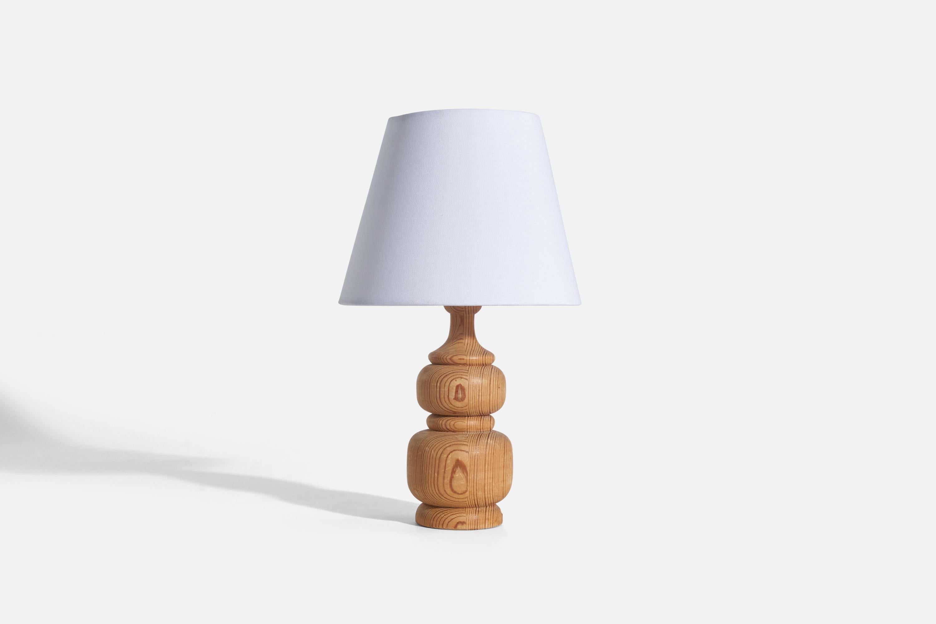 A pine table lamp designed and produced in Sweden, 1970s.

Sold without lampshade(s)
Dimensions of lamp (inches) : 9.93 x 3.59 x 3.59 (height x width x depth)
Dimensions of shade (inches) : 5 x 8.18 x 6.5 (top diameter x bottom diameter x