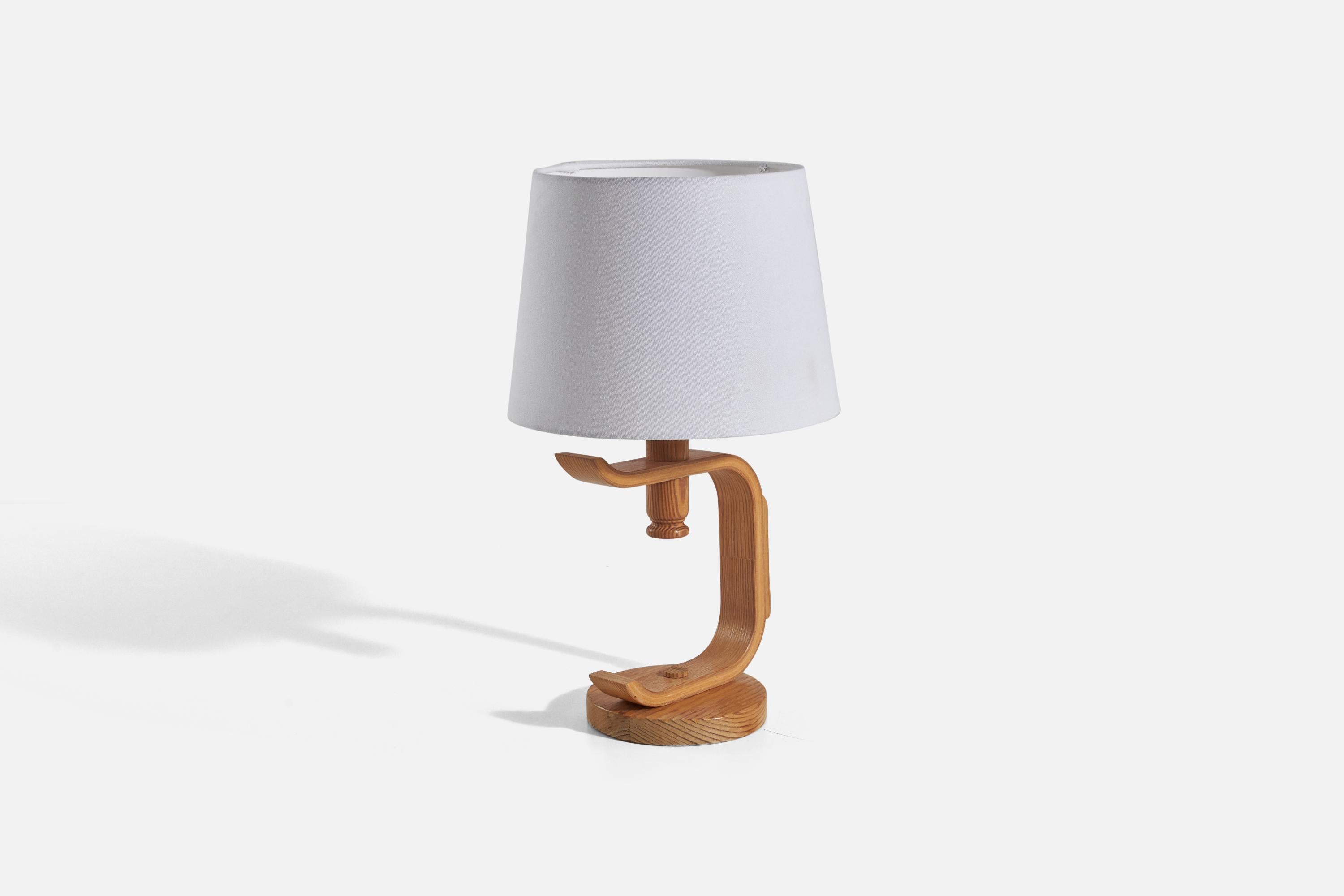A pine table lamp designed and produced in Sweden, 1970s.

Sold without lampshade(s)
Dimensions of lamp (inches) : 11.81 x 5.51 x 7.56 (Height x Width x Depth)
Dimensions of shade (inches) : 8 x 10 x 7.5 (Top Diameter x Bottom Diameter x