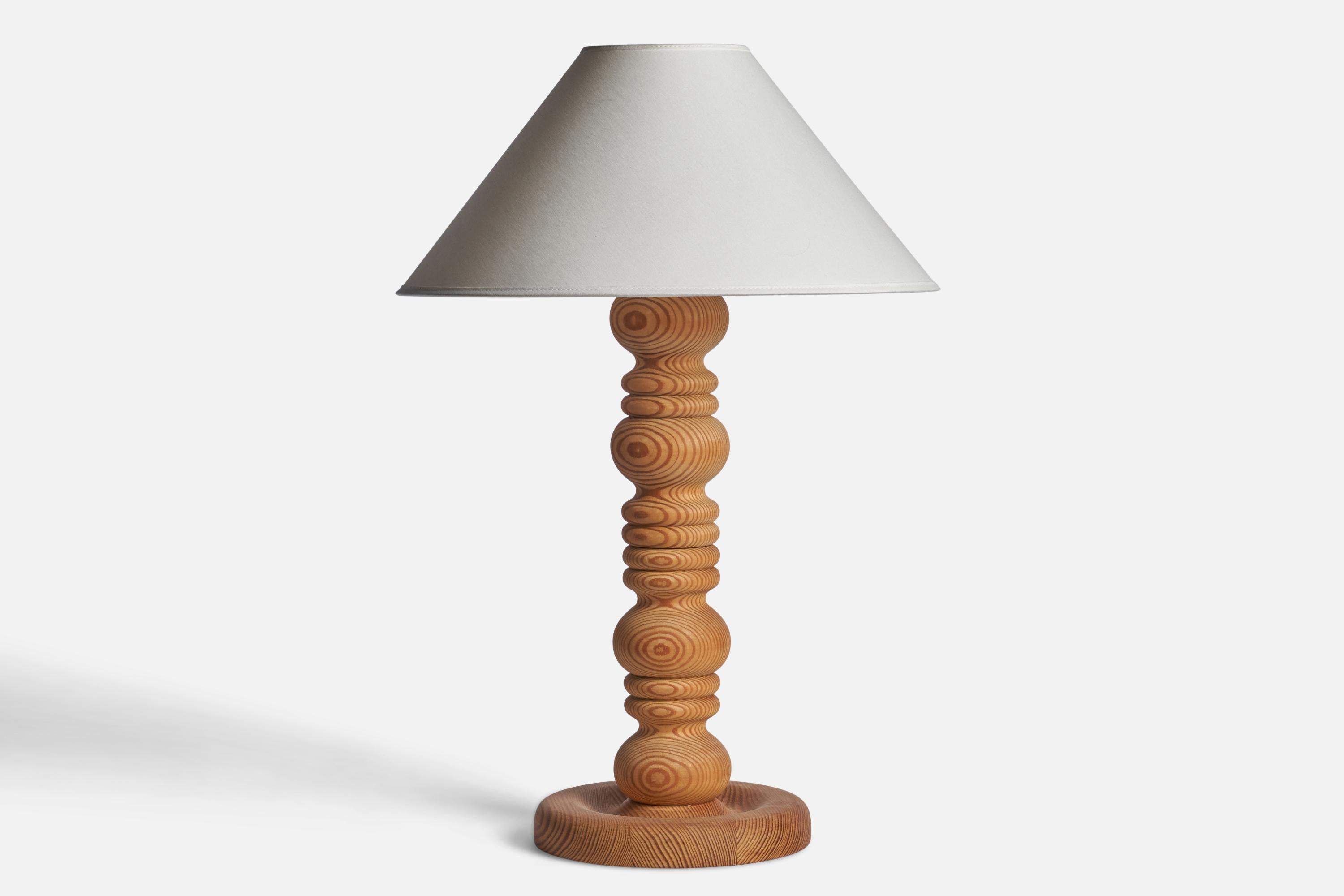 A sizeable pine table lamp designed and produced in Sweden, 1970s.

Dimensions of Lamp (inches): 18.5 H x 8.25” Diameter
Dimensions of Shade (inches): 4.5” Top Diameter x 16” Bottom Diameter x 7.25” H
Dimensions of Lamp with Shade (inches): 23.75” H