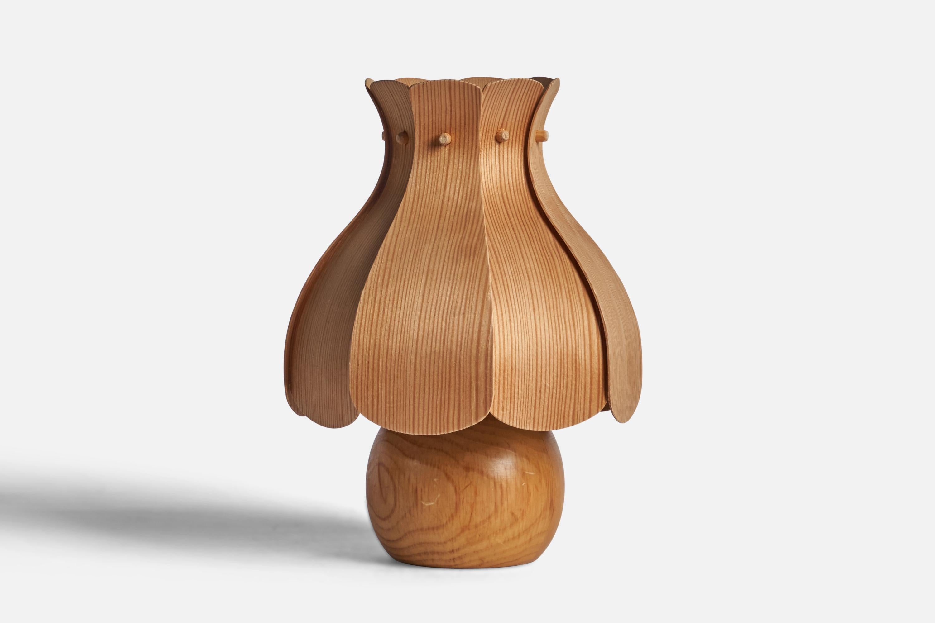 A pine and moulded pine veneer table lamp designed and produced in Sweden, 1970s.

Overall Dimensions (inches): 10.75” H x 7.5” Diameter
Bulb Specifications: E-26 Bulb
Number of Sockets: 1
All lighting will be converted for US usage. We are unable