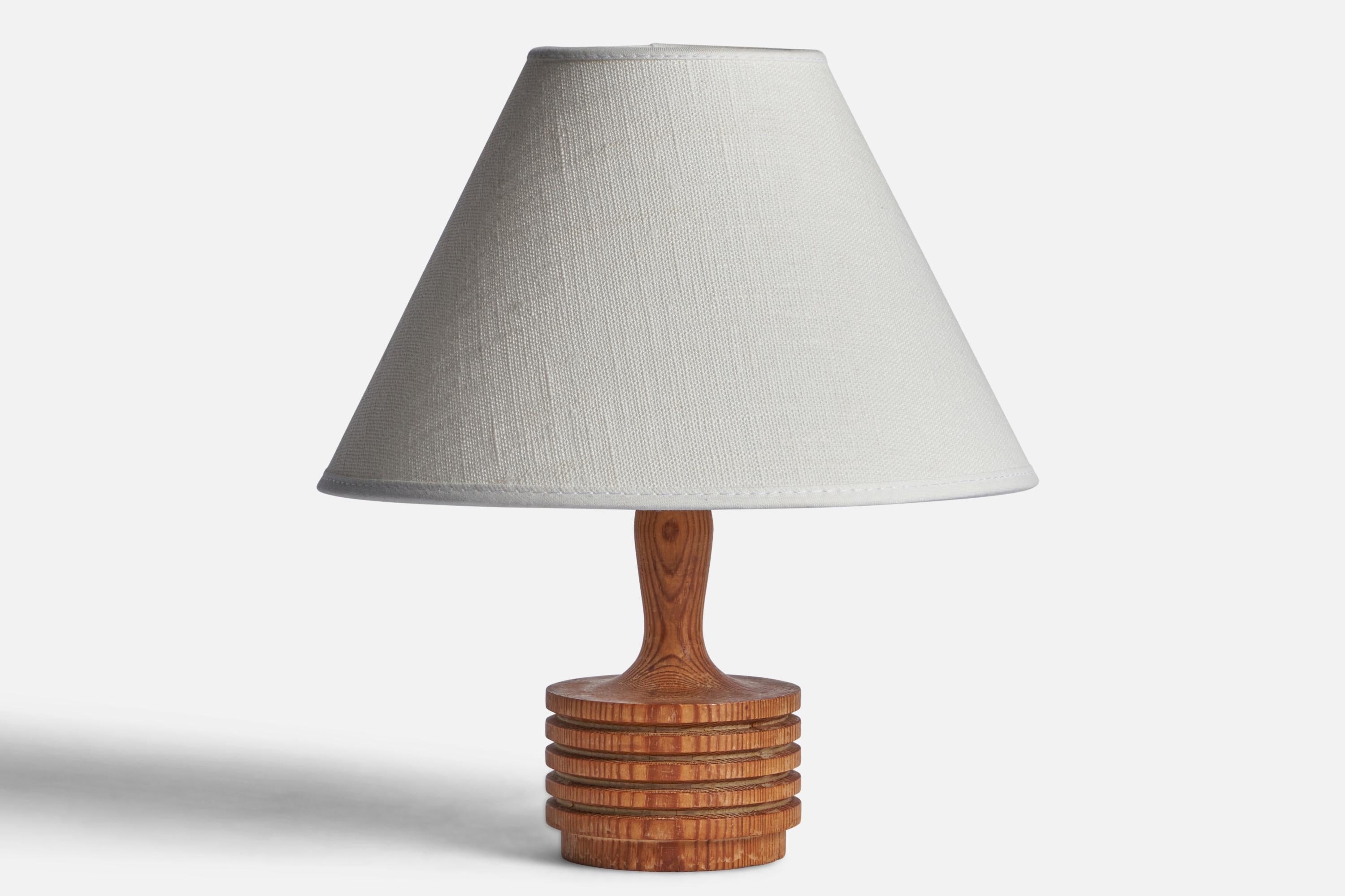 A turned pine table lamp designed and produced in Sweden, c. 1970s.

Dimensions of Lamp (inches): 6” H x 2.9” Diameter
Dimensions of Shade (inches): 3” Top Diameter x 8” Bottom Diameter x 5” H 
Dimensions of Lamp with Shade (inches): 9.25” H x 8”
