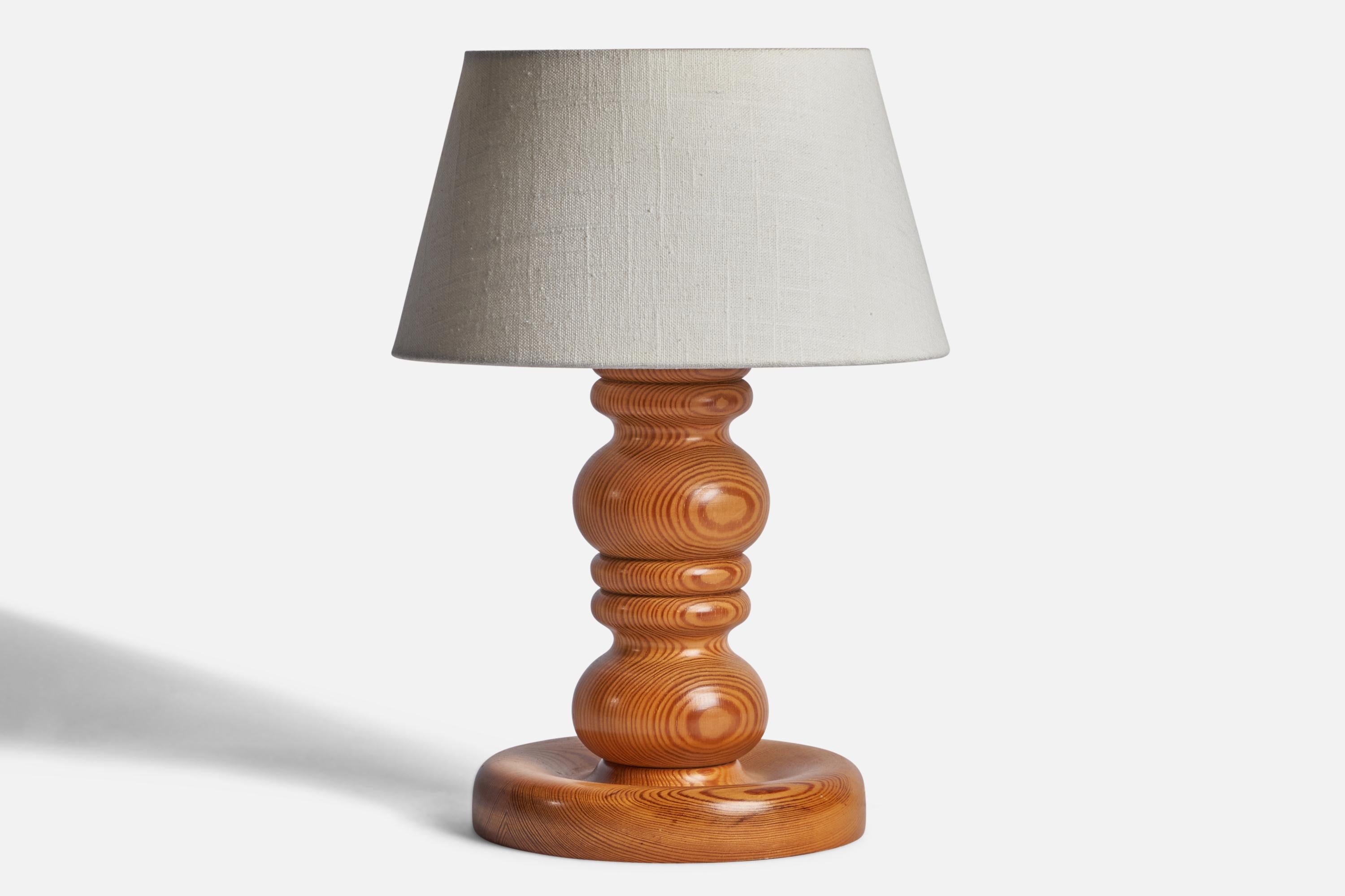 A pine table lamp designed and produced in Sweden, 1970s.

Dimensions of Lamp (inches): 11.25” H x 7.2” Diameter
Dimensions of Shade (inches): 7” Top Diameter x 10” Bottom Diameter x 5.5” H 
Dimensions of Lamp with Shade (inches): 14.5” H x 10”