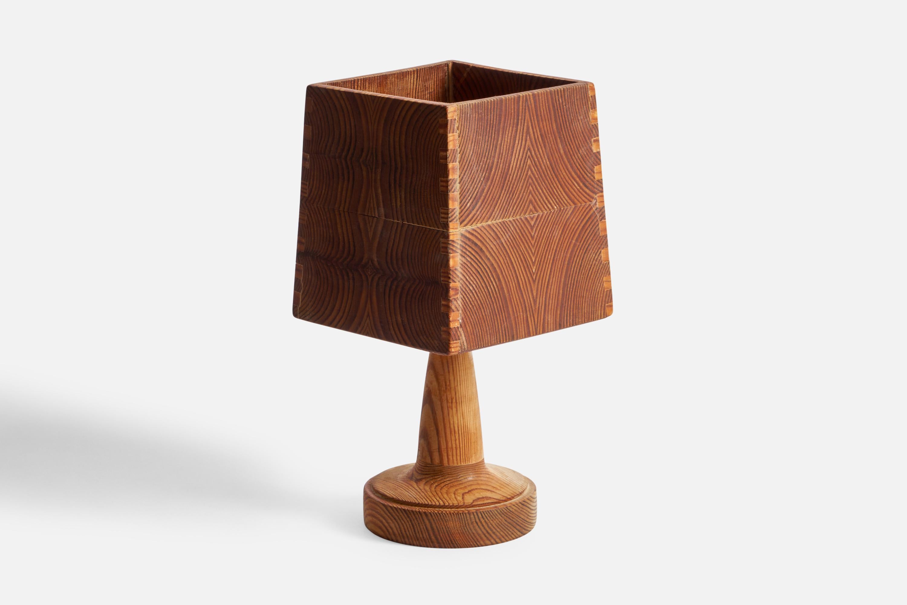 A pine table lamp designed and produced in Sweden, 1970s.

Overall Dimensions (inches): 10.38” H x 5.25” W x 5.25” D
Bulb Specifications: E-26 Bulb
Number of Sockets: 1
All lighting will be converted for US usage. We are unable to confirm that any