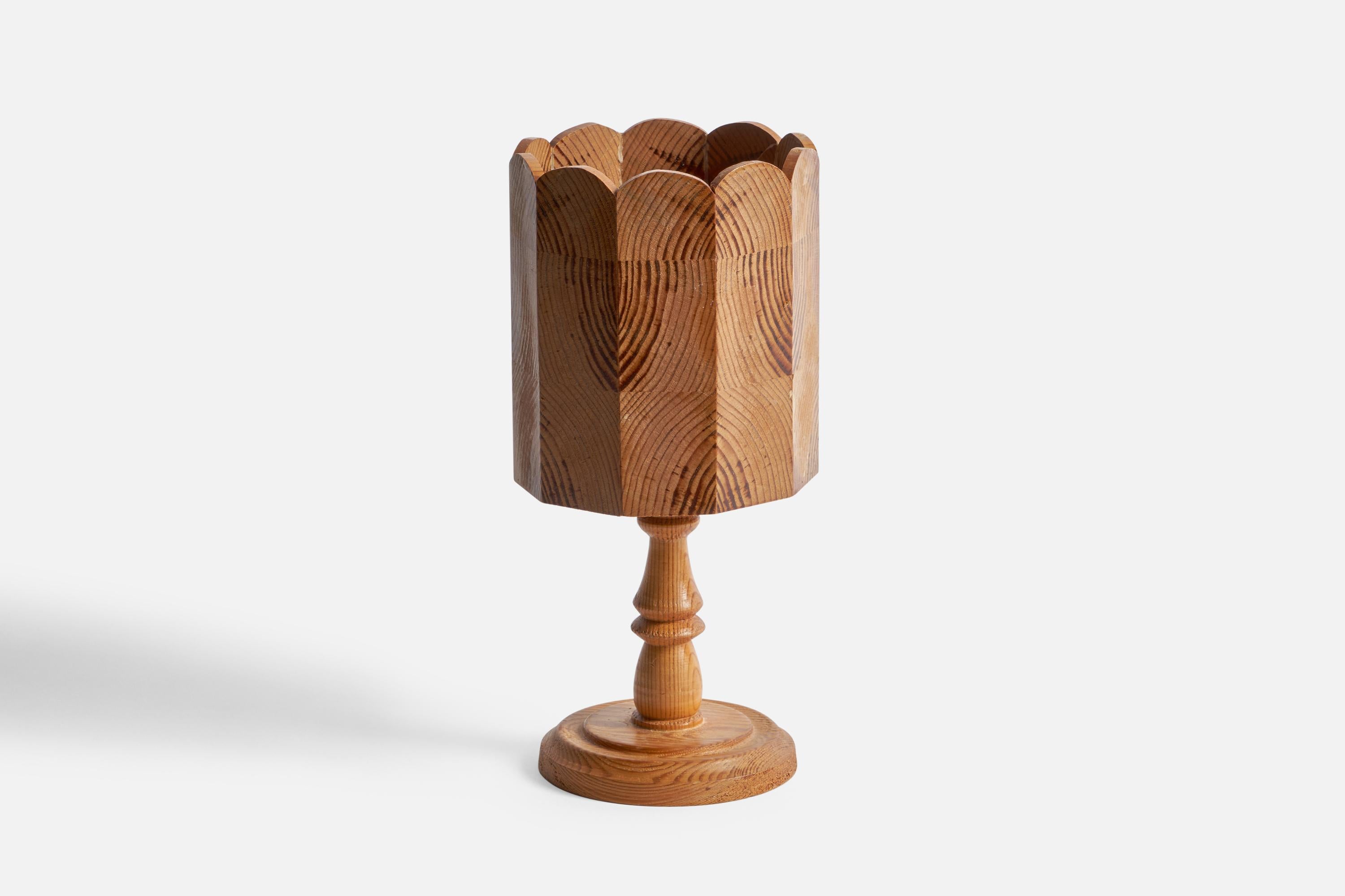 A pine table lamp designed and produced in Sweden, 1970s.

Overall Dimensions (inches): 11.8” H x 5.5” Diameter
Bulb Specifications: E-14 Bulb
Number of Sockets: 1
All lighting will be converted for US usage. We are unable to confirm that any