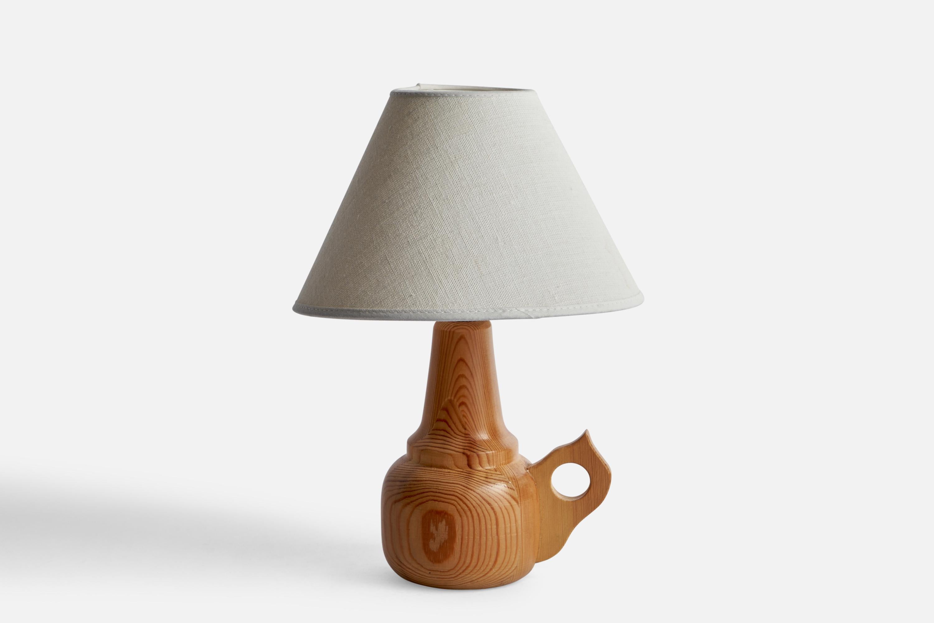A pine table lamp designed and produced in Sweden, 1970s.

Dimensions of Lamp (inches): 8.1” H x 3.82” W x 5.45” D
Dimensions of Shade (inches): 3” Top Diameter x 8” Bottom Diameter x 5” H
Dimensions of Lamp with Shade (inches): 11.7”H x 8”