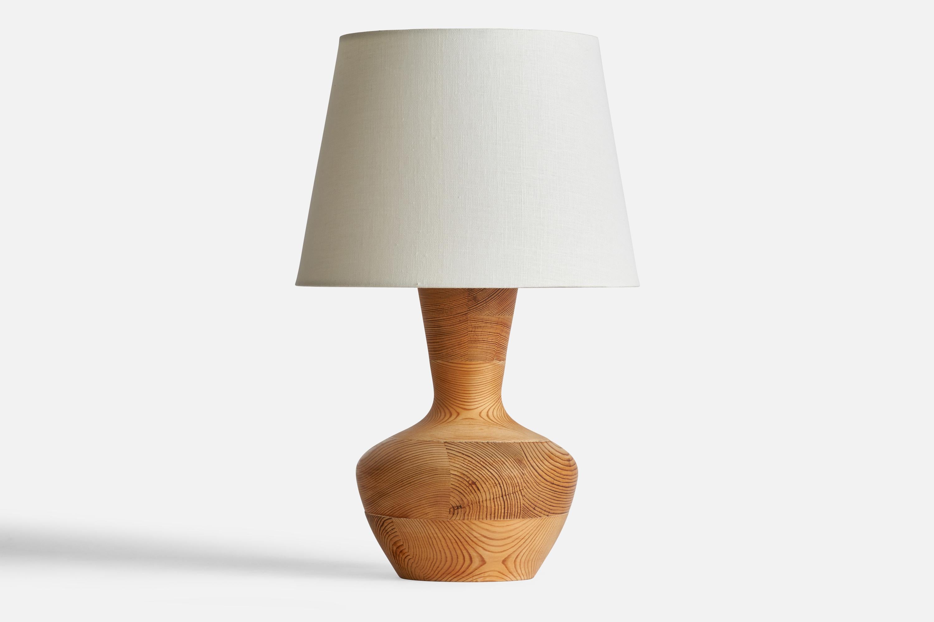A turned pine table lamp designed and produced in Sweden, 1970s.

Dimensions of Lamp (inches): 113.5” H x 7.85” Diameter
Dimensions of Shade (inches): 9” Top Diameter x 12” Bottom Diameter x 9” H
Dimensions of Lamp with Shade (inches): 19.75” H x