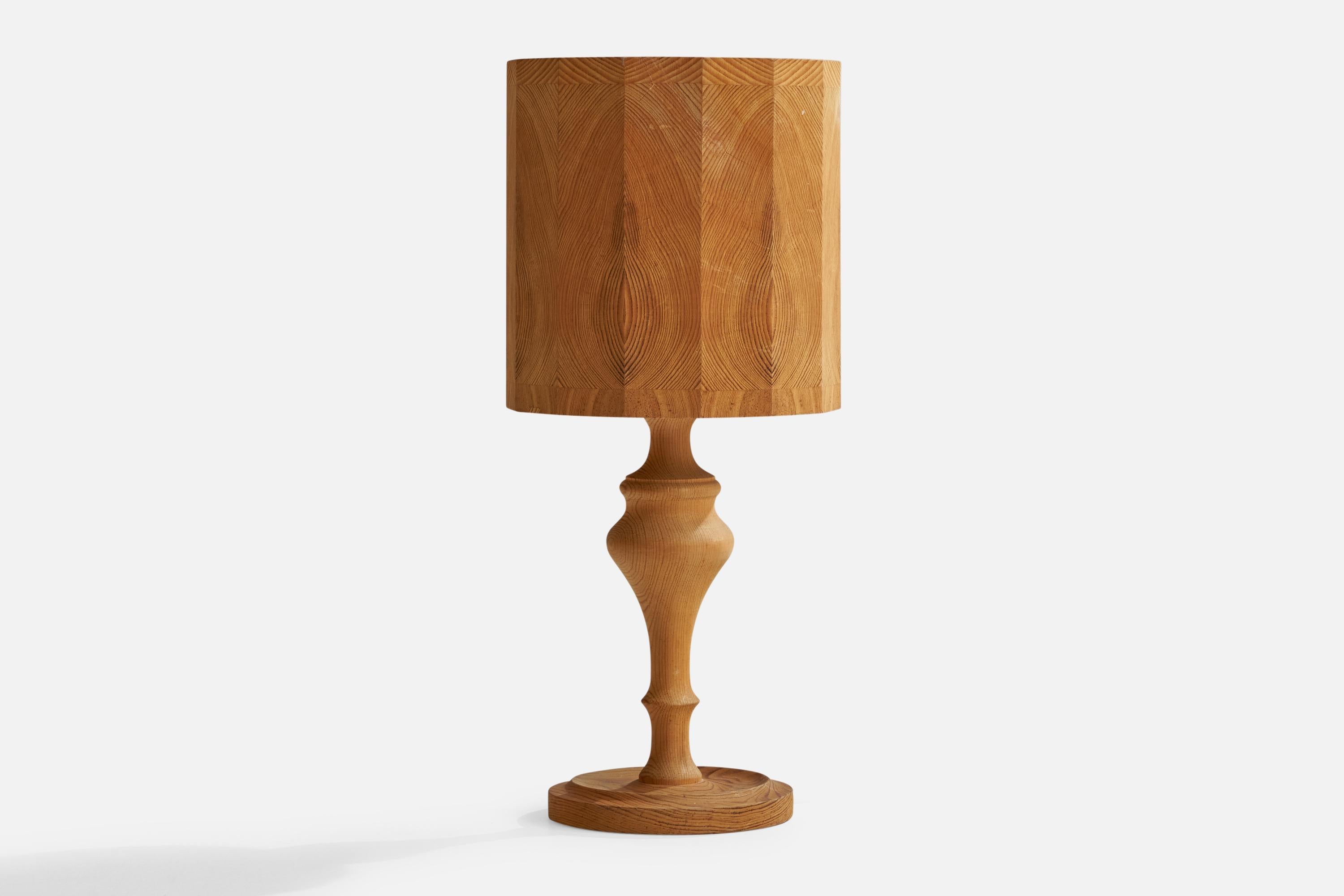A pine table lamp designed and produced in Sweden, 1970s.

Overall Dimensions (inches): 16”  H x 6.75” W x 5”  D
Stated dimensions include shade.
Bulb Specifications: E-26 Bulb
Number of Sockets: 1
All lighting will be converted for US usage. We is