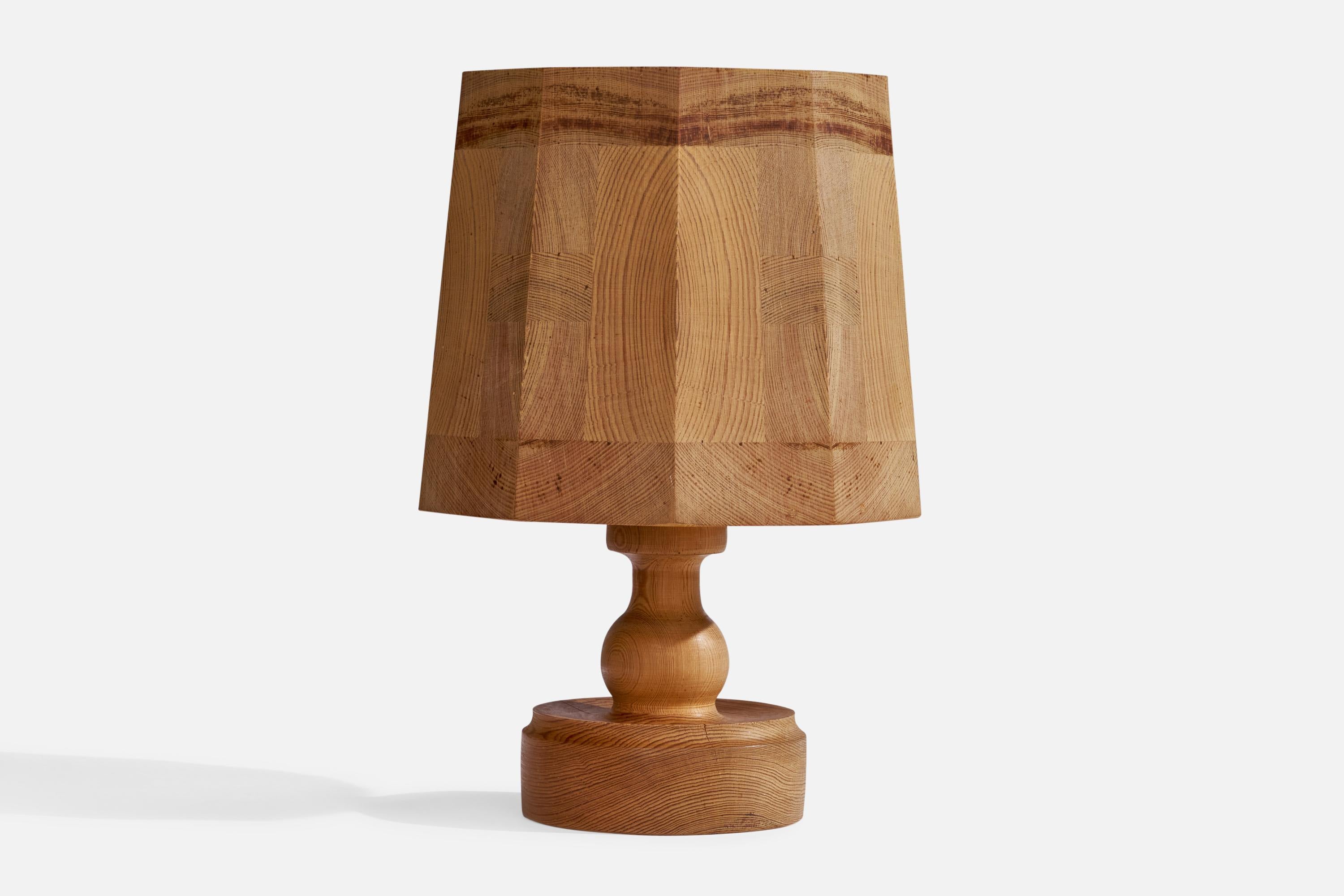 A pine table lamp designed and produced in Sweden, 1970s.

Overall Dimensions (inches): 12.25” H x 7”  W x 8.25”  D
Stated dimensions include shade.
Bulb Specifications: E-26 Bulb
Number of Sockets: 1
All lighting will be converted for US usage. We
