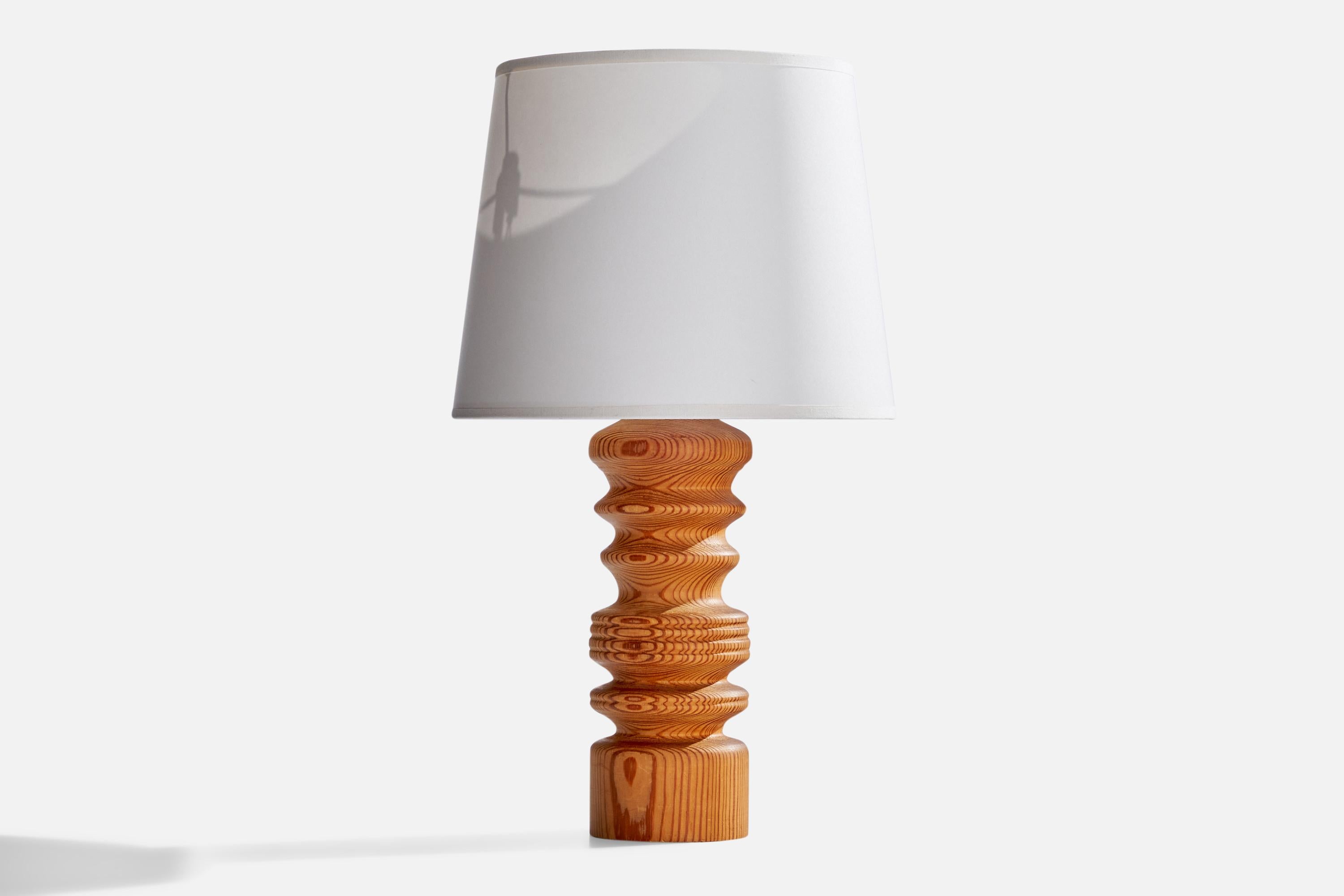 A pine table lamp designed and produced in Sweden, c. 1970s.

Dimensions of Lamp (inches): 12”  H x 3.5”  Diameter
Dimensions of Shade (inches): 8” Top Diameter x 10” Bottom Diameter x 8” H
Dimensions of Lamp with Shade (inches): 17”  H x 10”