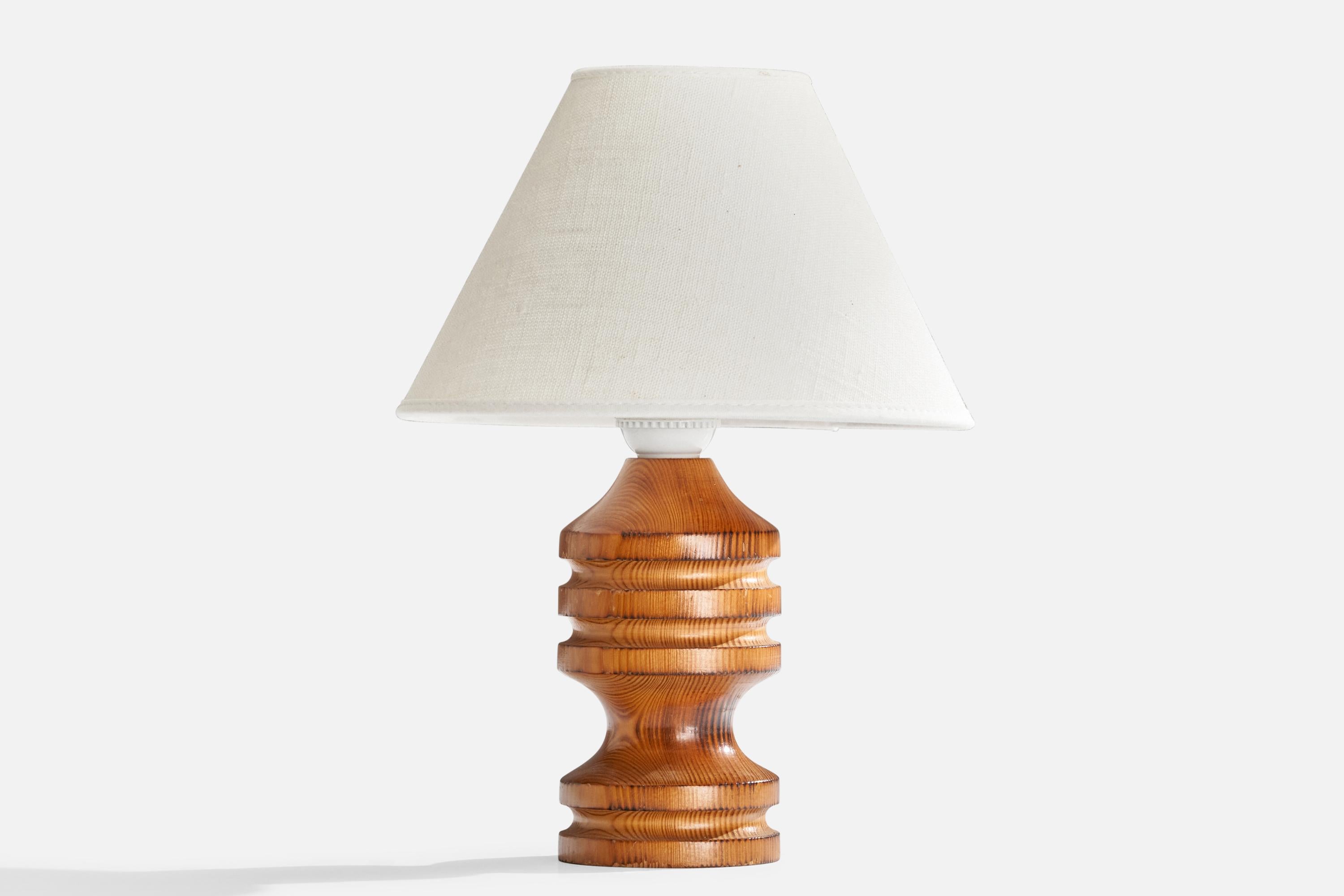 A pine table lamp designed and produced in Sweden, c. 1970s.

Dimensions of Lamp (inches): 7.75” H x 3.25”  Diameter
Dimensions of Shade (inches): 3.25” Top Diameter x 8” Bottom Diameter x 5.5” H
Dimensions of Lamp with Shade (inches): 11” H x 8”