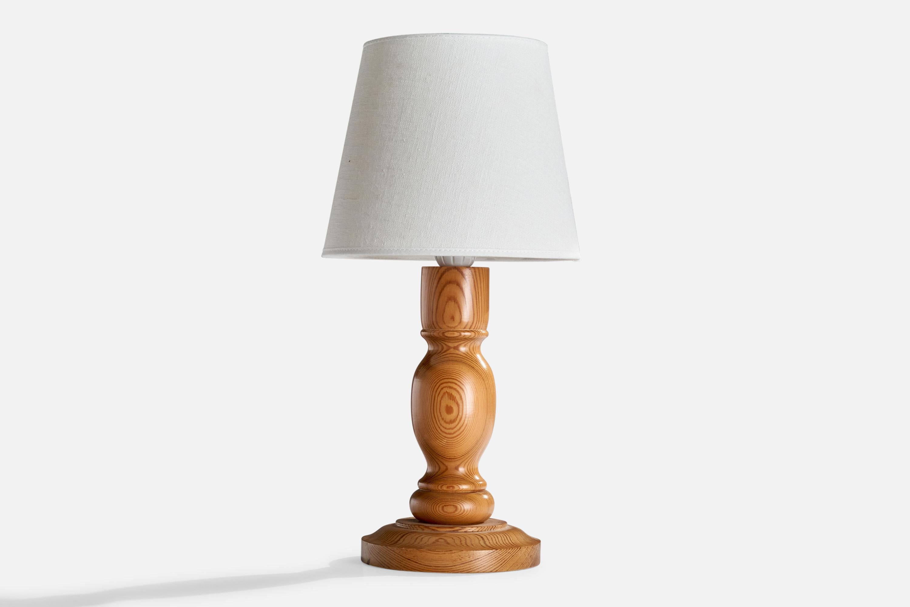 A pine table lamp designed and produced in Sweden, c. 1970s.

Dimensions of Lamp (inches): 11” H x 5.625” W x 5.625” D
Dimensions of Shade (inches): 5.75” Top Diameter x 8” Bottom Diameter x 6.75