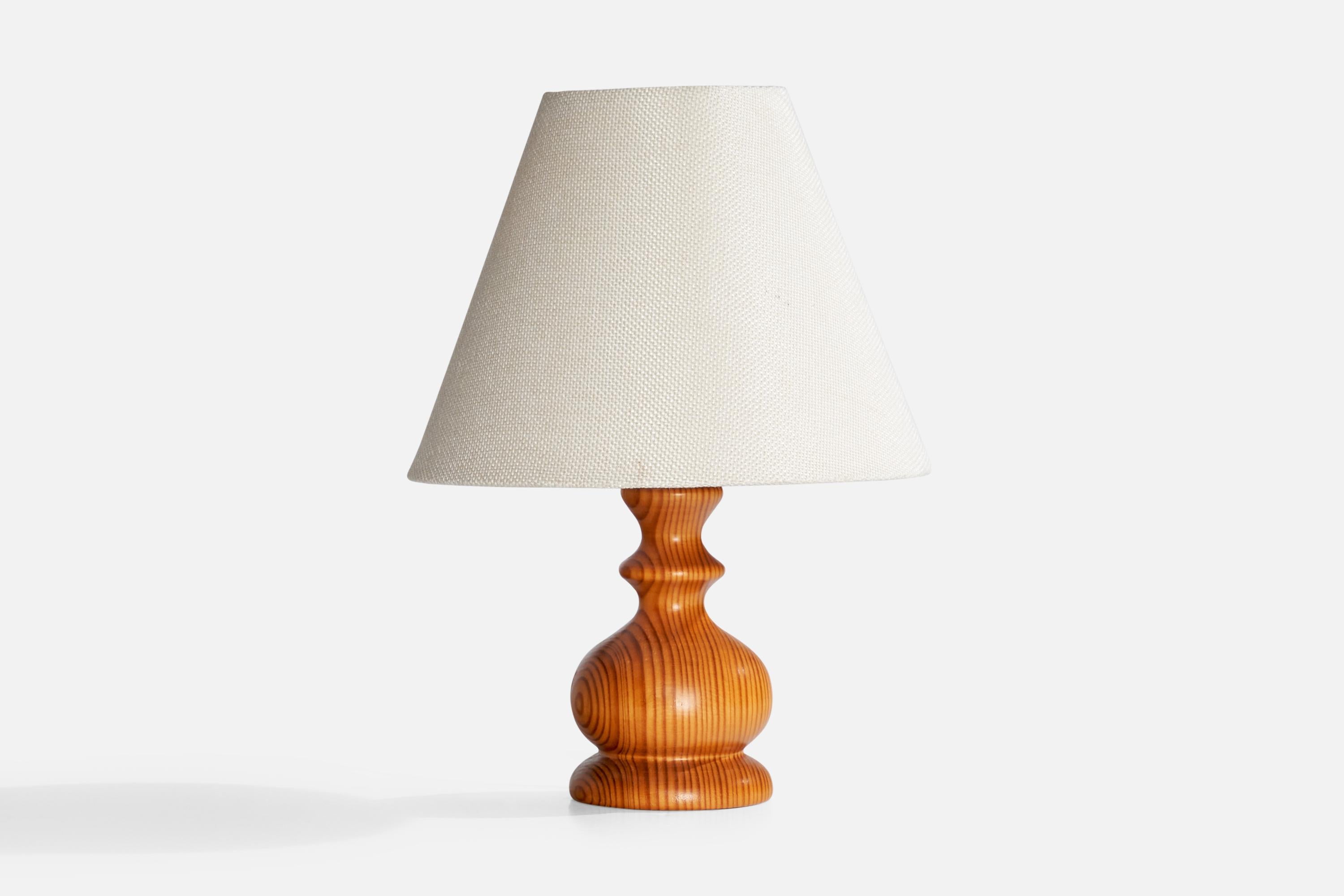 A pine table lamp designed and produced in Sweden, c. 1970s.

Dimensions of Lamp (inches):  6.75“ H x  3“ W x  3“ D

Dimensions of Shade (inches):  3.75“ Top Diameter x  8“ Bottom Diameter x  6.25“ H

Dimensions of Lamp with Shade (inches): 10.5” H