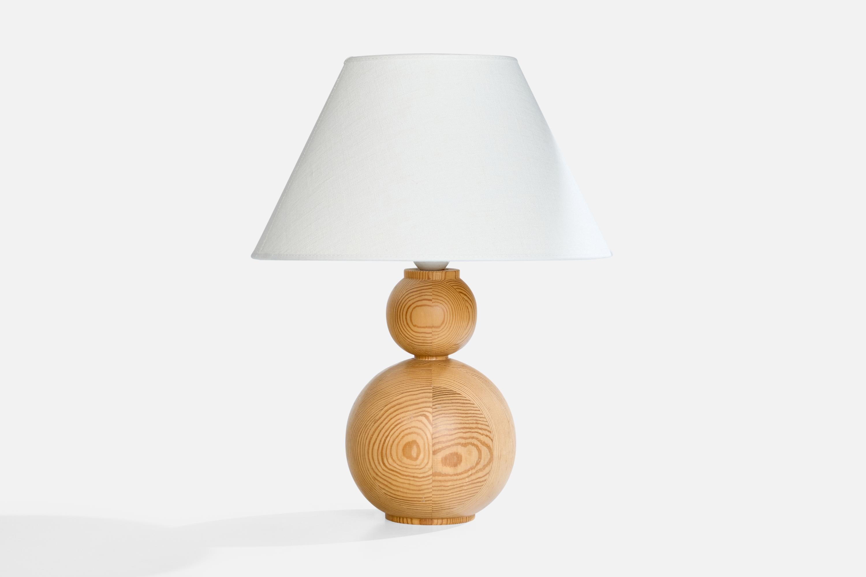 A pine table lamp designed and produced in Sweden, c. 1970s.

Dimensions of Lamp (inches): 11“ H x 6“ Diameter

Dimensions of Shade (inches): 6“ Top Diameter x 13“ Bottom Diameter x 7.75“ H

Dimensions of Lamp with Shade (inches): 16“ H x 13“