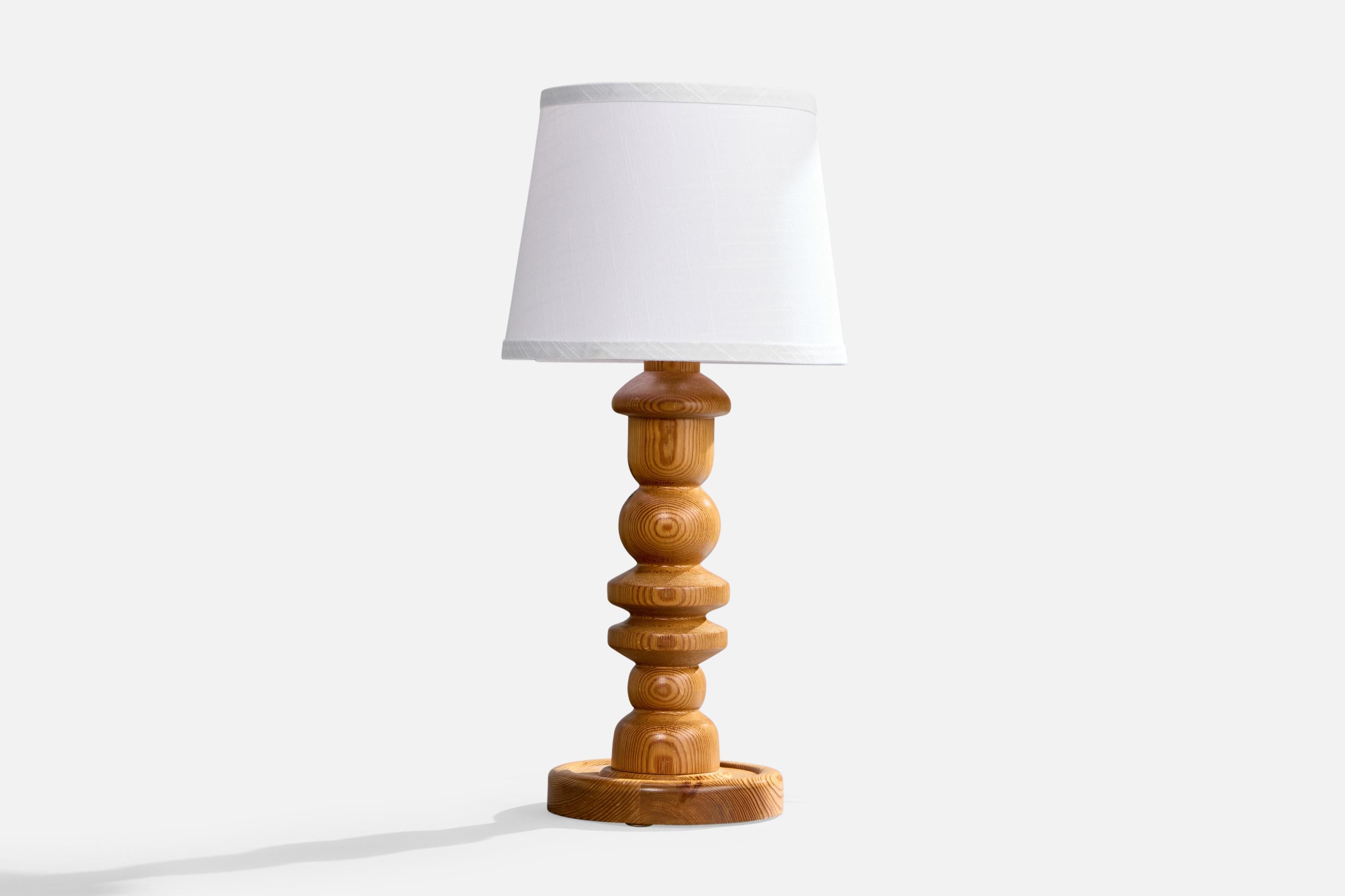 A pine table lamp designed and produced in Sweden, c. 1970s.

Dimensions of Lamp (inches): 16” H x 7” Diameter

Dimensions of Shade (inches): 8”  Top Diameter x 10” Bottom Diameter x 8” H

Dimensions of Lamp with Shade (inches): 21.5”H x 10”