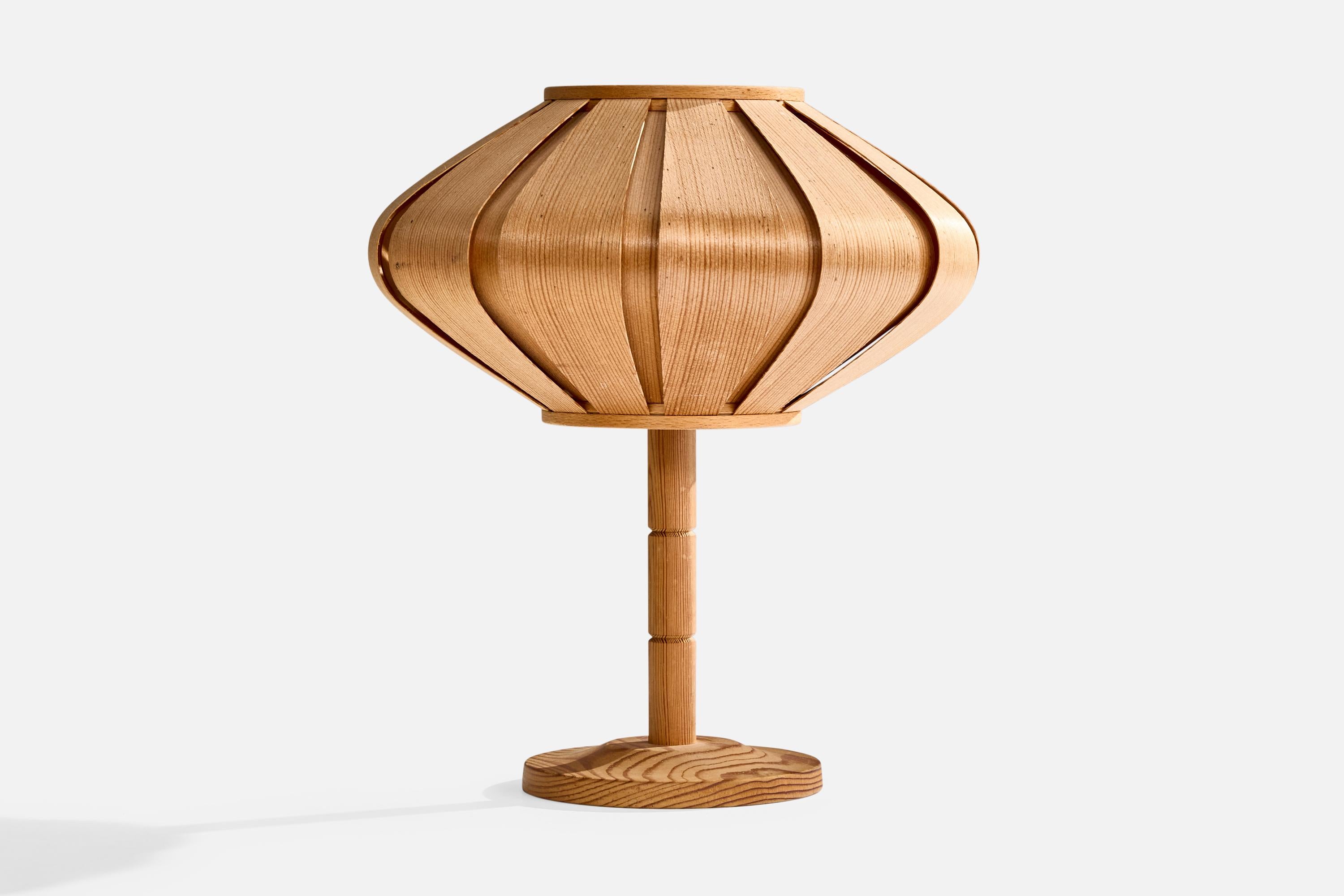 A pine table lamp designed and produced in Sweden, c. 1970s.

Dimensions of Lamp with Shade (inches): 9.5