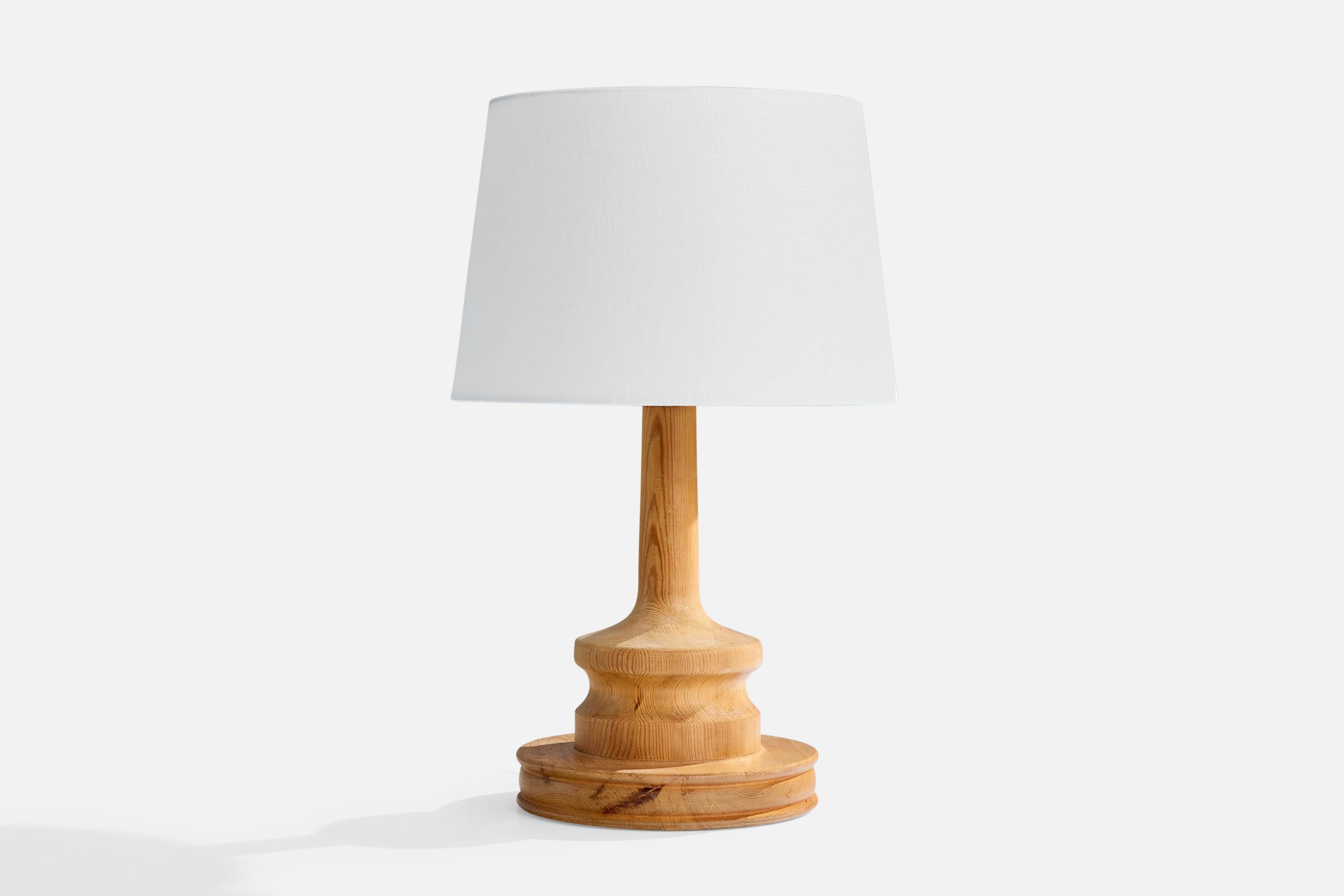 A pine table lamp designed and produced in Sweden, c. 1970s.

Wear consistent with age and use

Dimensions of Shade (inches): 10” Top Diameter x 12” Bottom Diameter x 8” Height

Dimensions of Lamp with Shade (inches): 19.25” Height x 12”