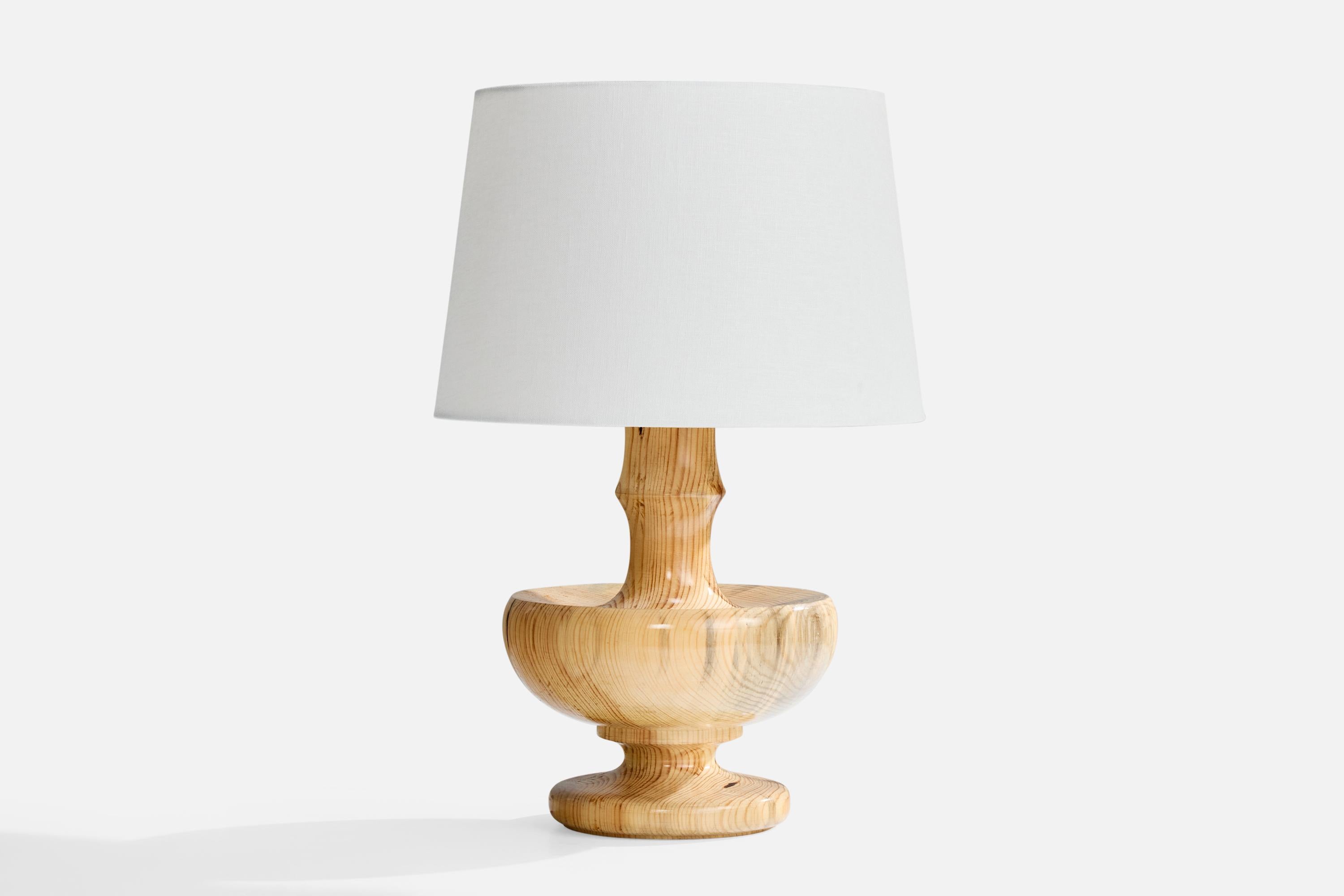 A pine table lamp designed and produced in Sweden, c. 1970s.

Dimensions of Shade (inches): 10” Top Diameter x 12” Bottom Diameter x 8” Height

Dimensions of Lamp with Shade (inches): 18.25” Height x 12” Diameter

Overall Dimensions (inches):