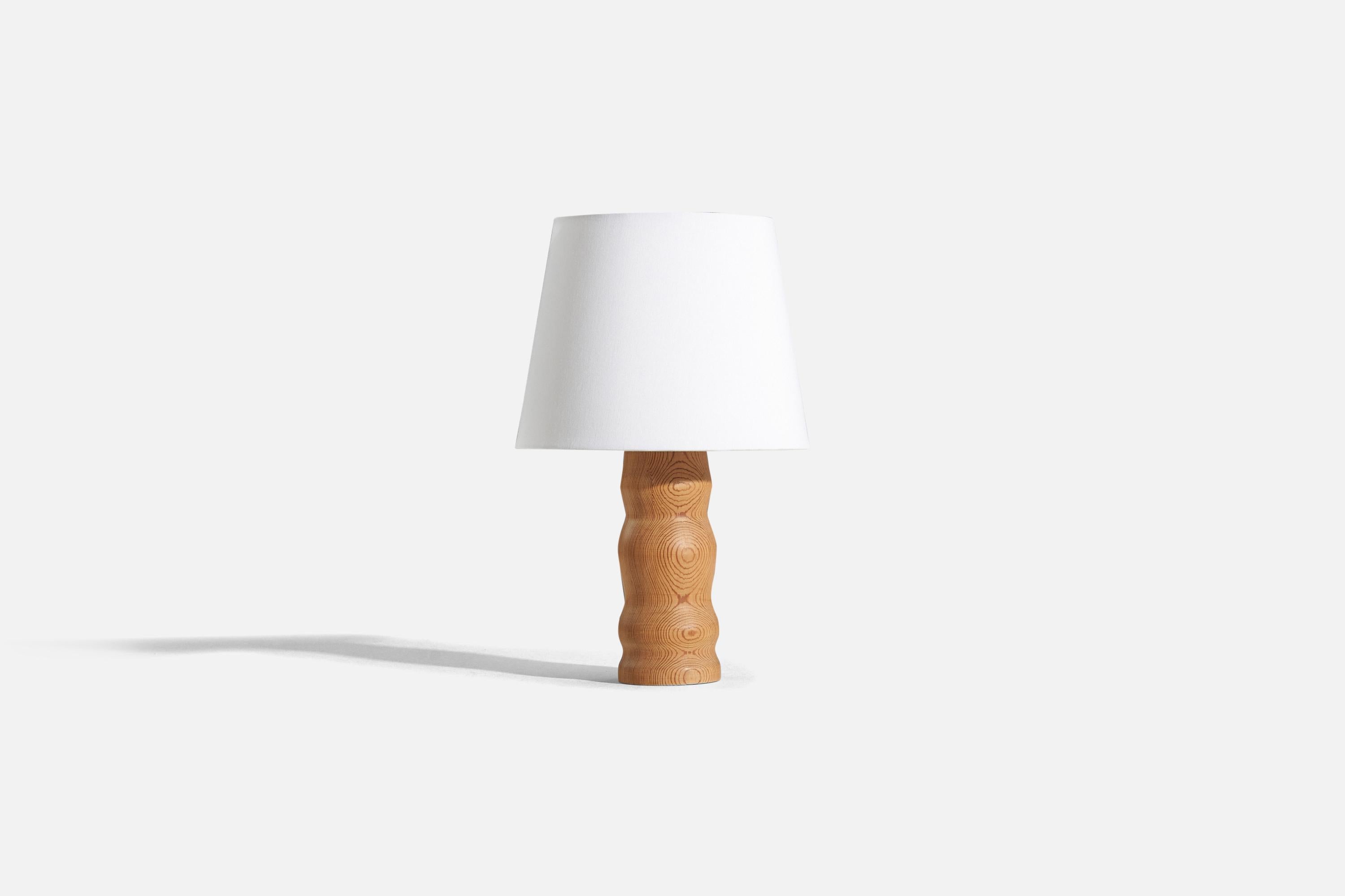 A pine table lamp designed and produced in Sweden, c. 1970s.

Sold without lampshade. 
Dimensions of Lamp (inches) : 11.875 x 3.5 x 3.5 (H x W x D)
Dimensions of Shade (inches) : 7.5 x 10 x 8 (T x B x S)
Dimension of Lamp with Shade (inches) :