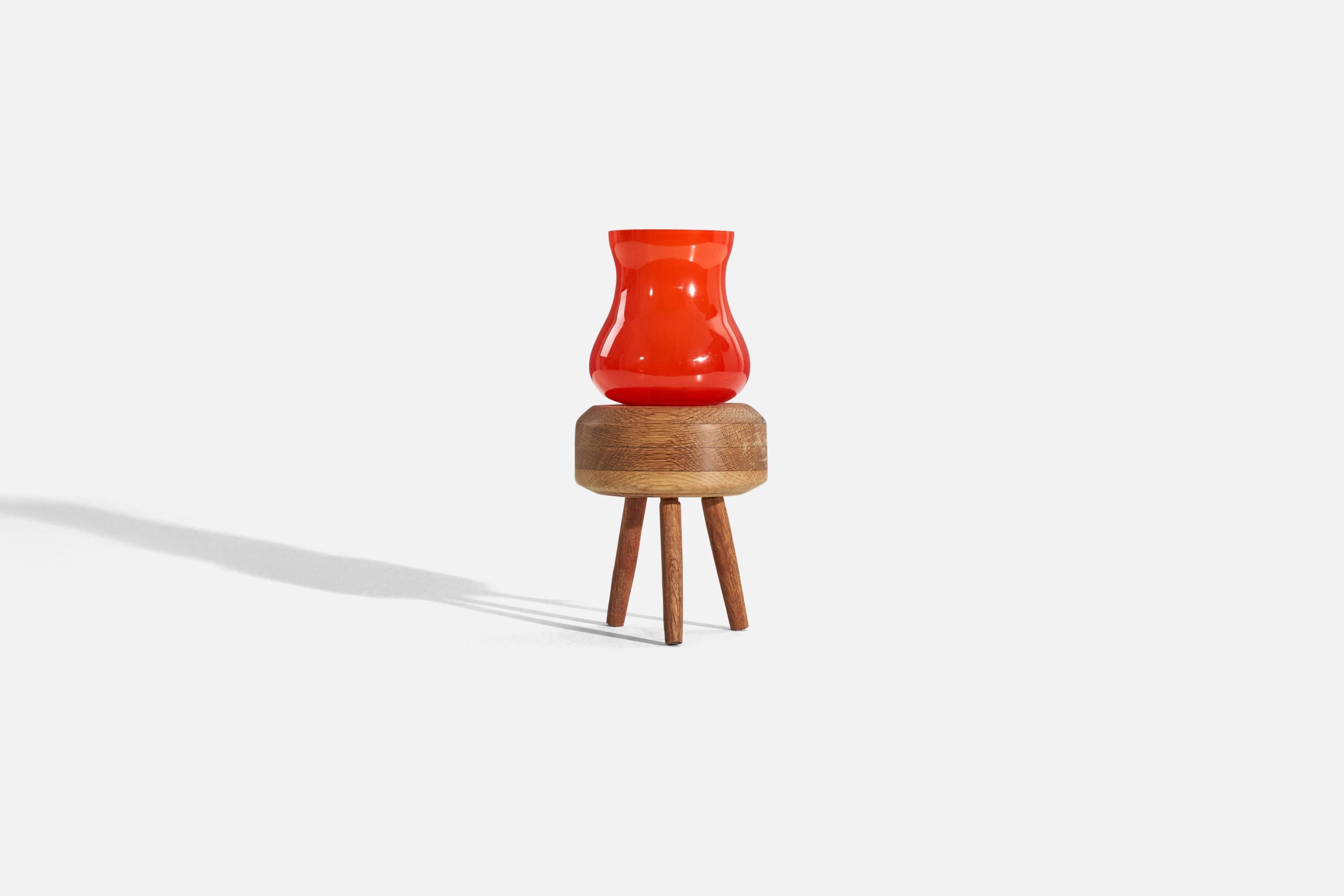 A red glass and oak table lamp, designed and produced in Sweden, c. 1960s. 


