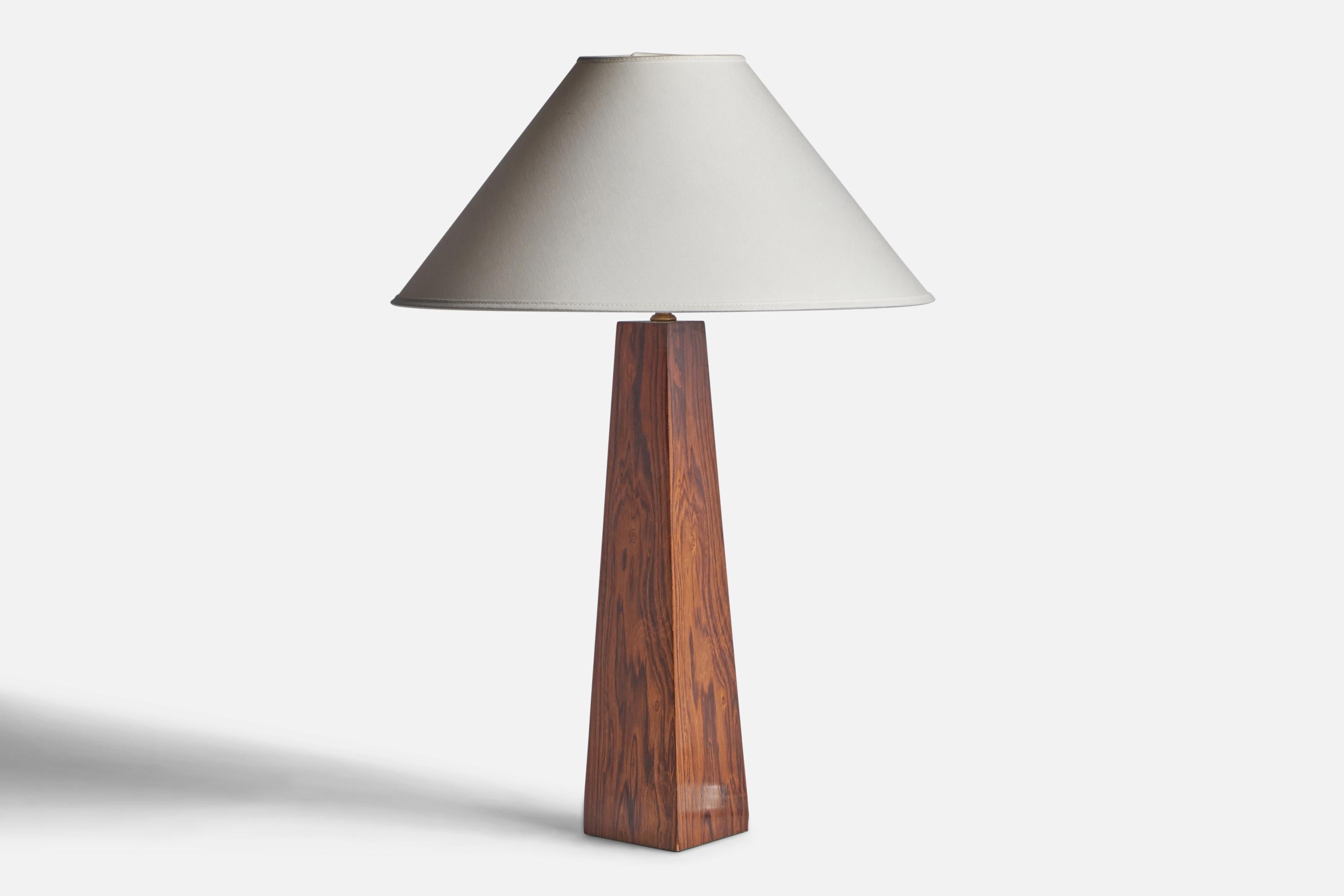 A rosewood veneered table lamp designed and produced in Sweden, c. 1950s.

Dimensions of Lamp (inches): 17.85” H x 6.3” Diameter
Dimensions of Shade (inches): 4.5” Top Diameter x 16” Bottom Diameter x 7.25” H
Dimensions of Lamp with Shade (inches):