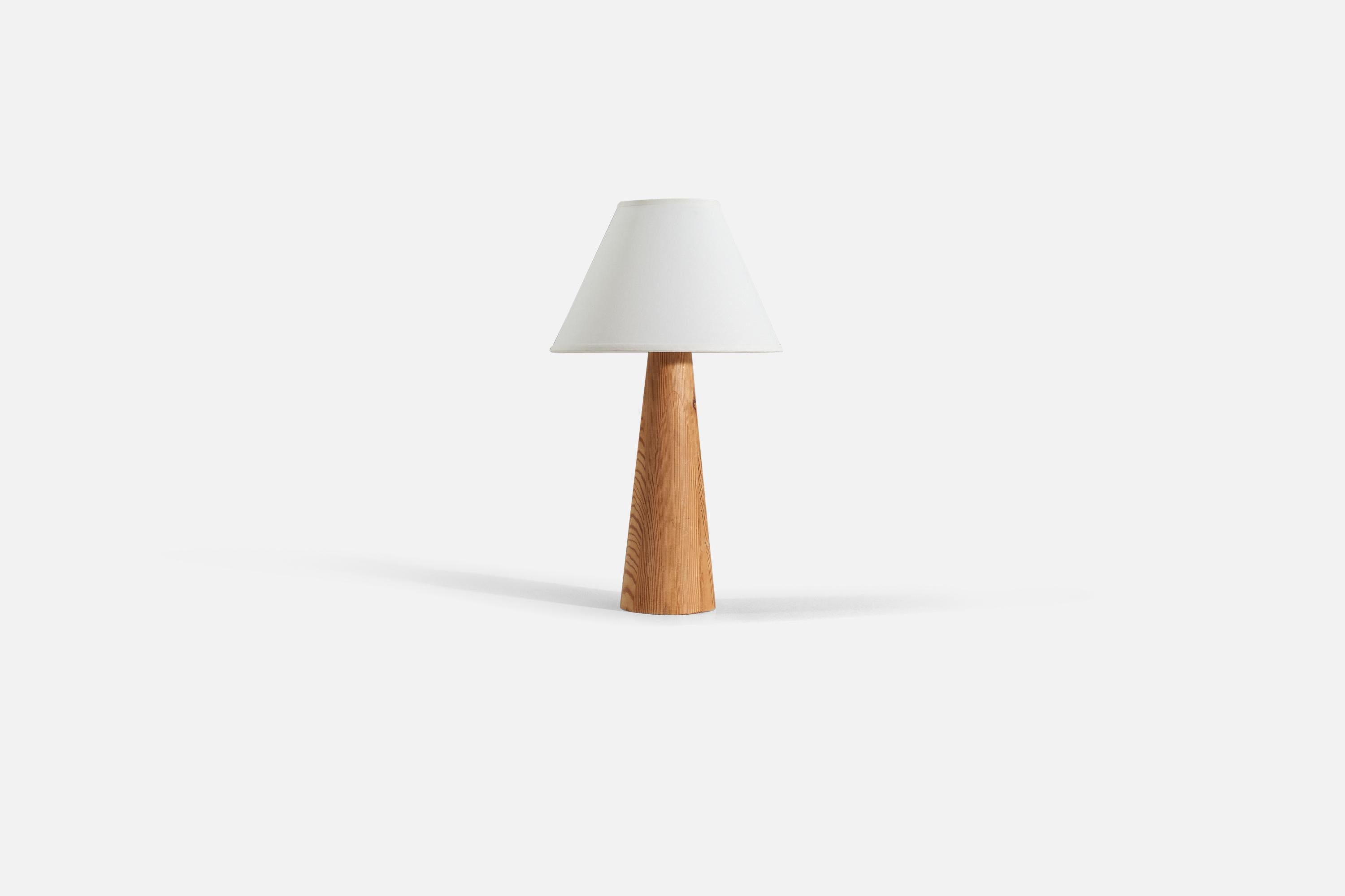 A turned solid pine table lamp, produced in Sweden, 1960s.

Sold without lampshade. 

Measurements listed are of lamp.
Shade : 5 x 12.25 x 8.75
Lamp with shade : 21.75 x 12.25 x 12.25
