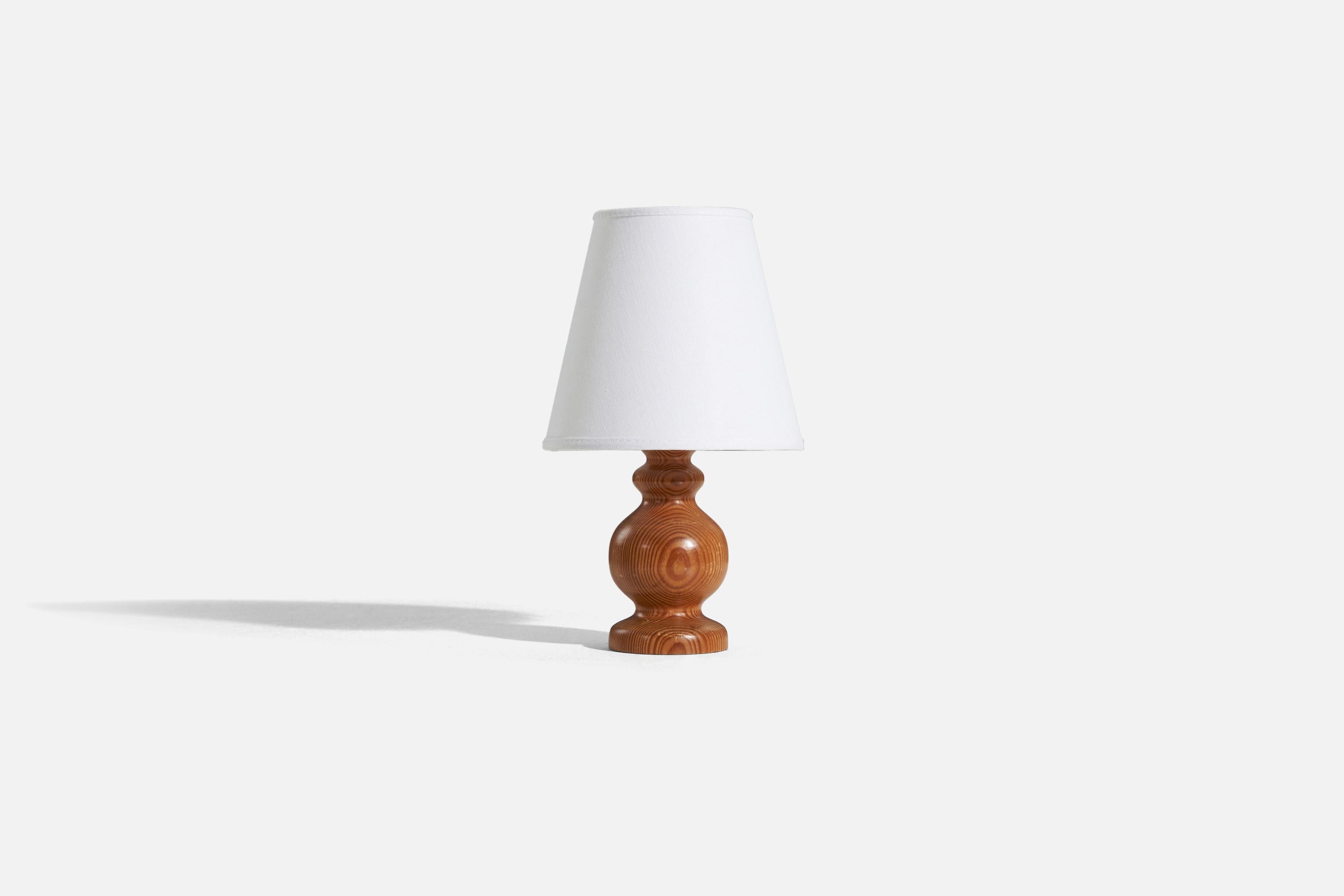 A solid pine table lamp designed and produced in Sweden, c. 1970s.

Sold without lampshade. 
Dimensions of Lamp (inches) : 8 x 3.125 x 3.125 (H x W x D)
Dimensions of Shade (inches) : 4 x 7 x 6.25 (T x B x H)
Dimension of Lamp with Shade
