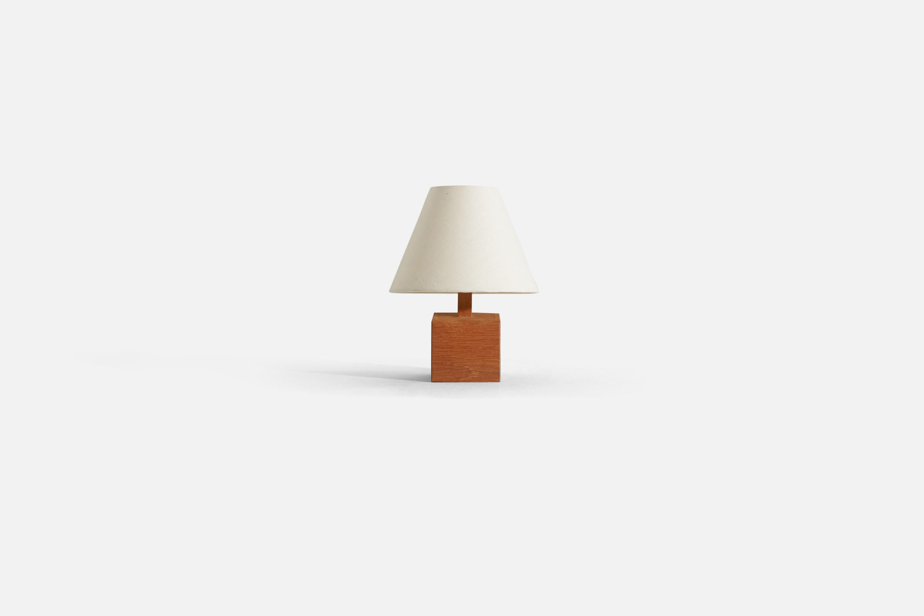 A solid teak cube / square table lamp designed and produced in Sweden, c. 1950s.

Sold without lampshade. Measurements listed are of lamp only. 

For reference
Shade : 4 x 8.25 x 6.25
Lamp with shade : 10.75 x 8.25 x 8.25.