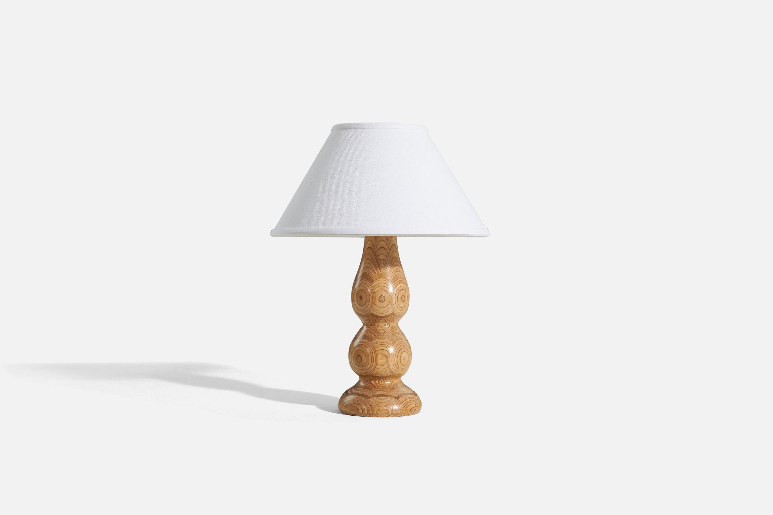 A laminated pine table lamp, designed and produced by a Swedish designer, Sweden, 1970s.

Sold without lampshade. 
Dimensions of Lamp (inches) : 13 x 4.75 x 4.75 (H x W x D)
Dimensions of Shade (inches) : 5 x 12.25 x 7.25 (T x B x H)
Dimension