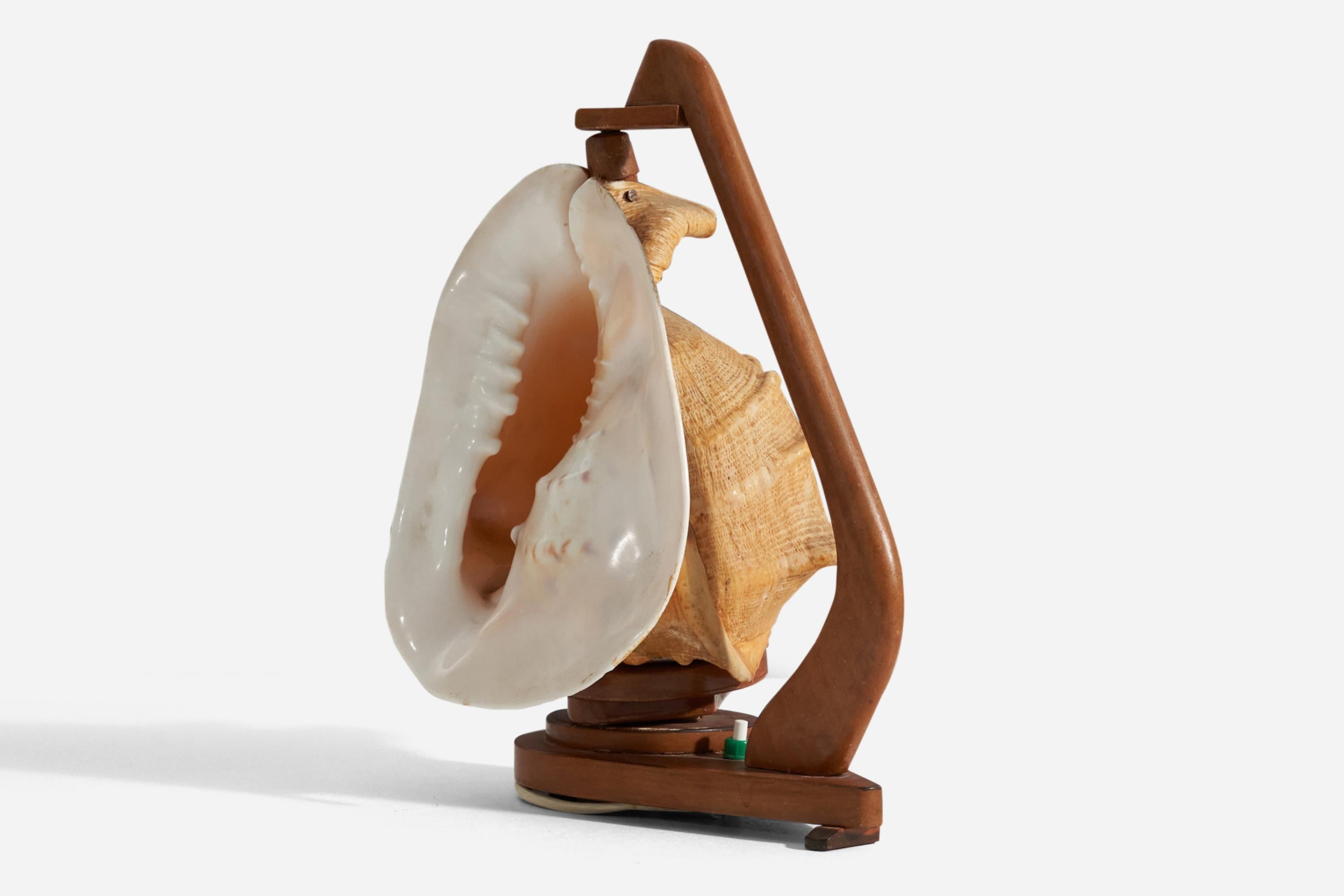 A table lamp in stained wood with an adjustable shell diffuser. Designed and produced in Sweden, c. 1940s.
