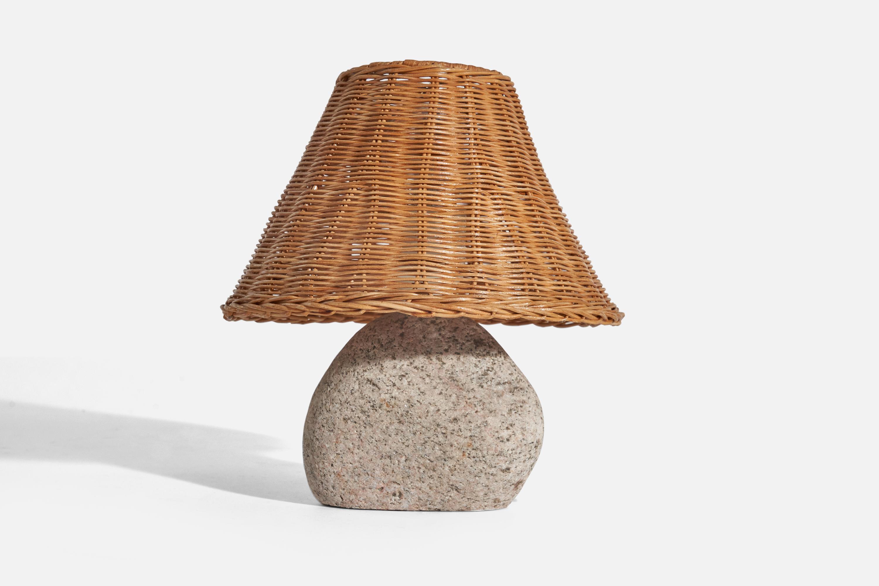 A stone table lamp designed and produced in Sweden, c. 1970s.

Sold with rattan Lampshade(s)
Dimensions of lamp (inches) : 11.87 x 7.06 x 4.43 (height x width x depth)
Dimensions of shade (inches) : 8.25 x 10.37 x 7.12 (top diameter x bottom