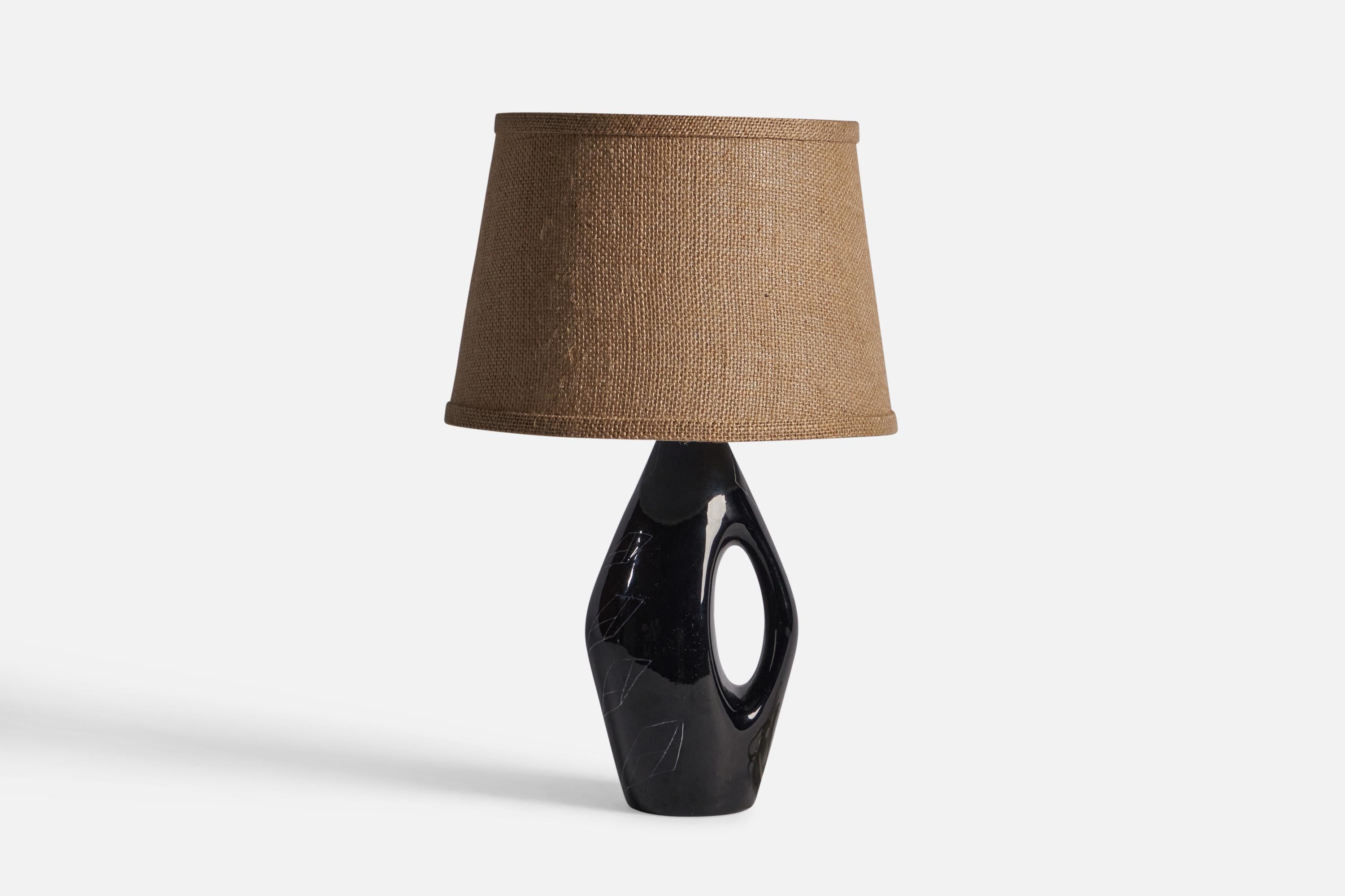A black-glazed stoneware lamp with incised decor, designed and produced in Sweden, 1960s.

Dimensions of Lamp (inches): 11.75