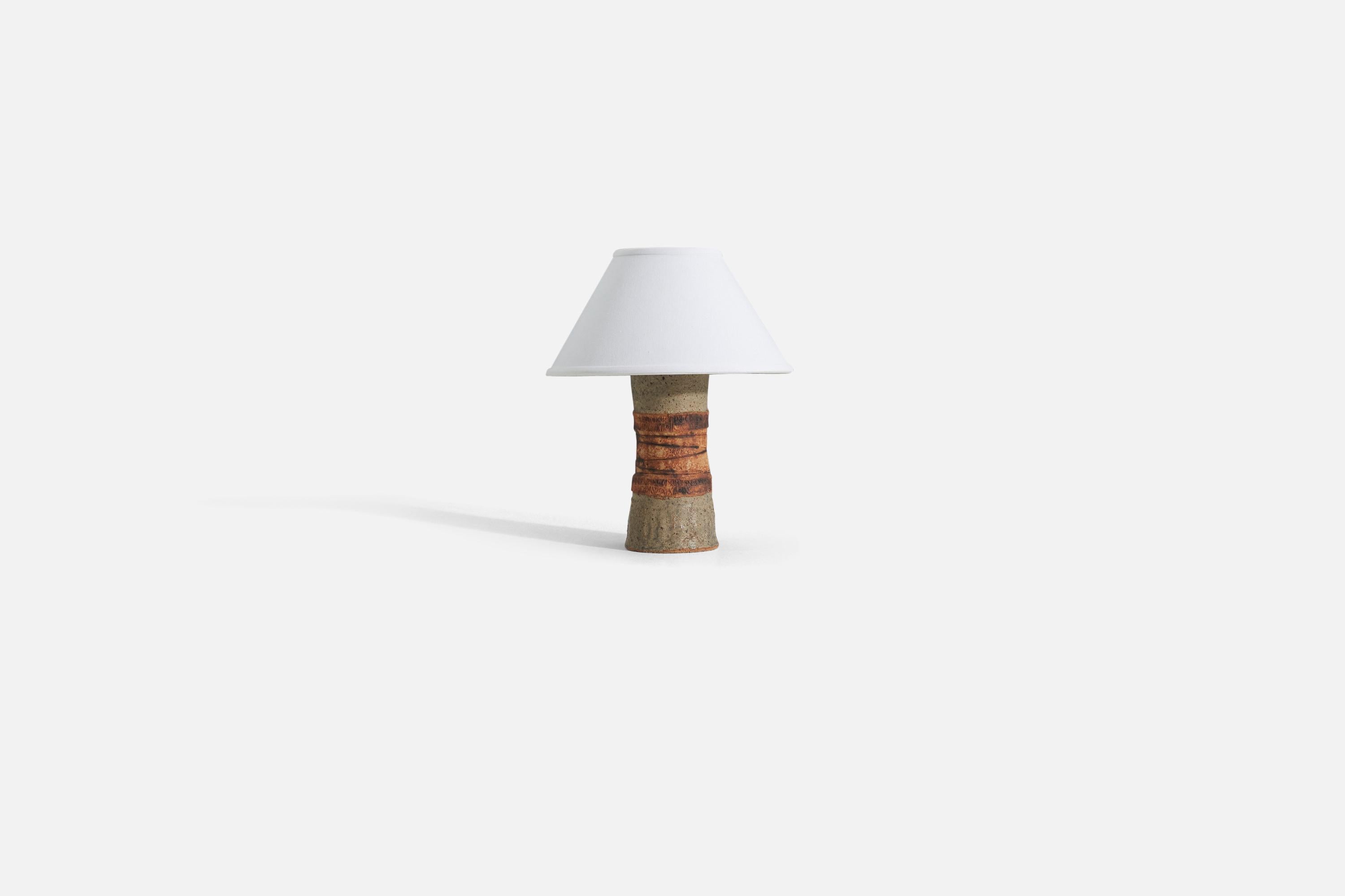 A stoneware table lamp produced in Sweden, 1960s.

Sold without lampshade. 
Dimensions of Lamp (inches) : 12 x 4.75 x 4.75 (H x W x D)
Dimensions of Shade (inches) : 5 x 12.25 x 7.25 (T x B x H)
Dimension of Lamp with shade (inches) : 15 x