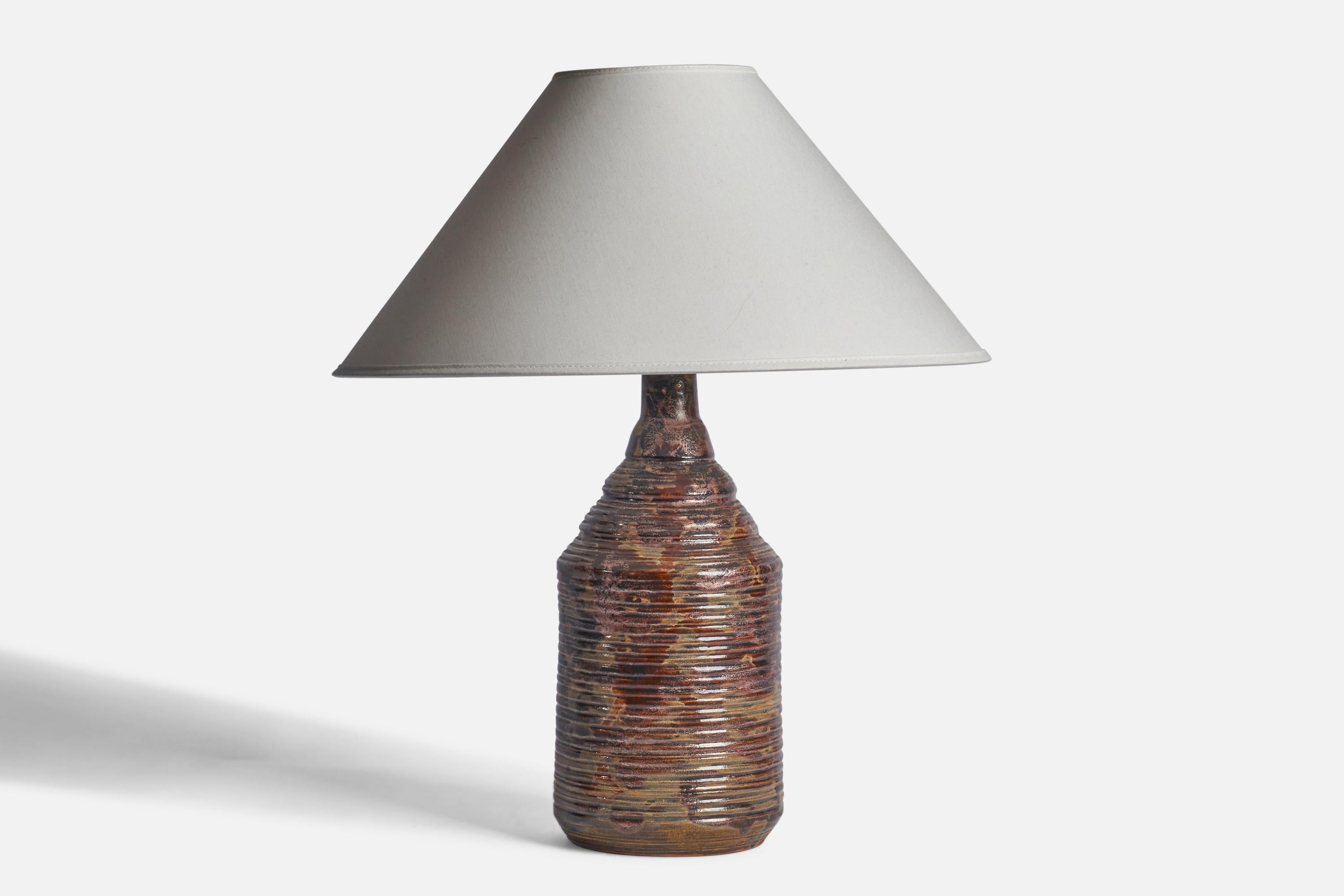 An incised brown-glazed stoneware table lamp designed and produced in Sweden, c. 1960s.

Dimensions of Lamp (inches): 14” H x 6