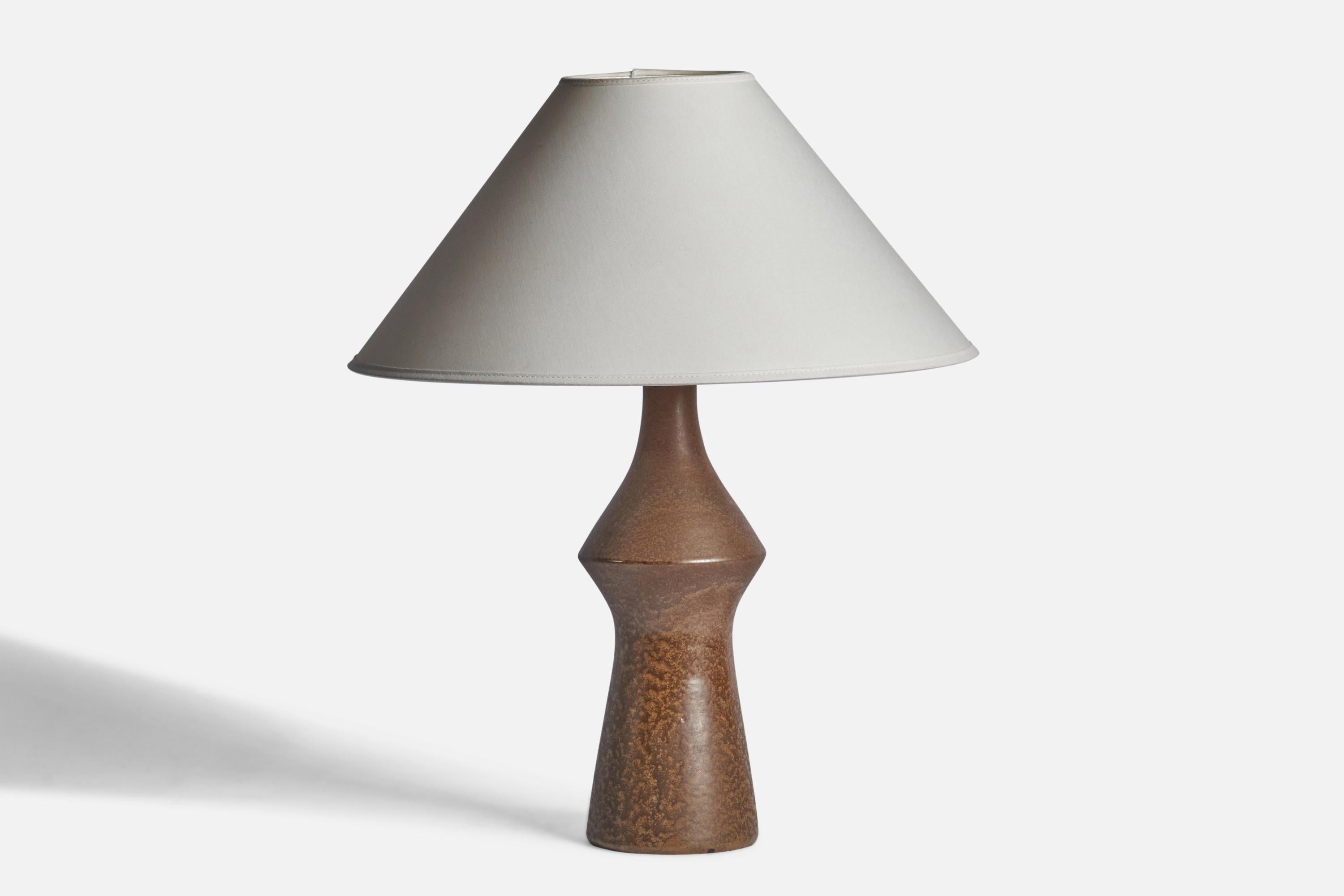 A brown-glazed stoneware table lamp designed and produced in Sweden, 1960s.

Dimensions of Lamp (inches): 15.25” H x 4.75” Diameter
Dimensions of Shade (inches): 4.5” Top Diameter x 16” Bottom Diameter x 7.25” H
Dimensions of Lamp with Shade