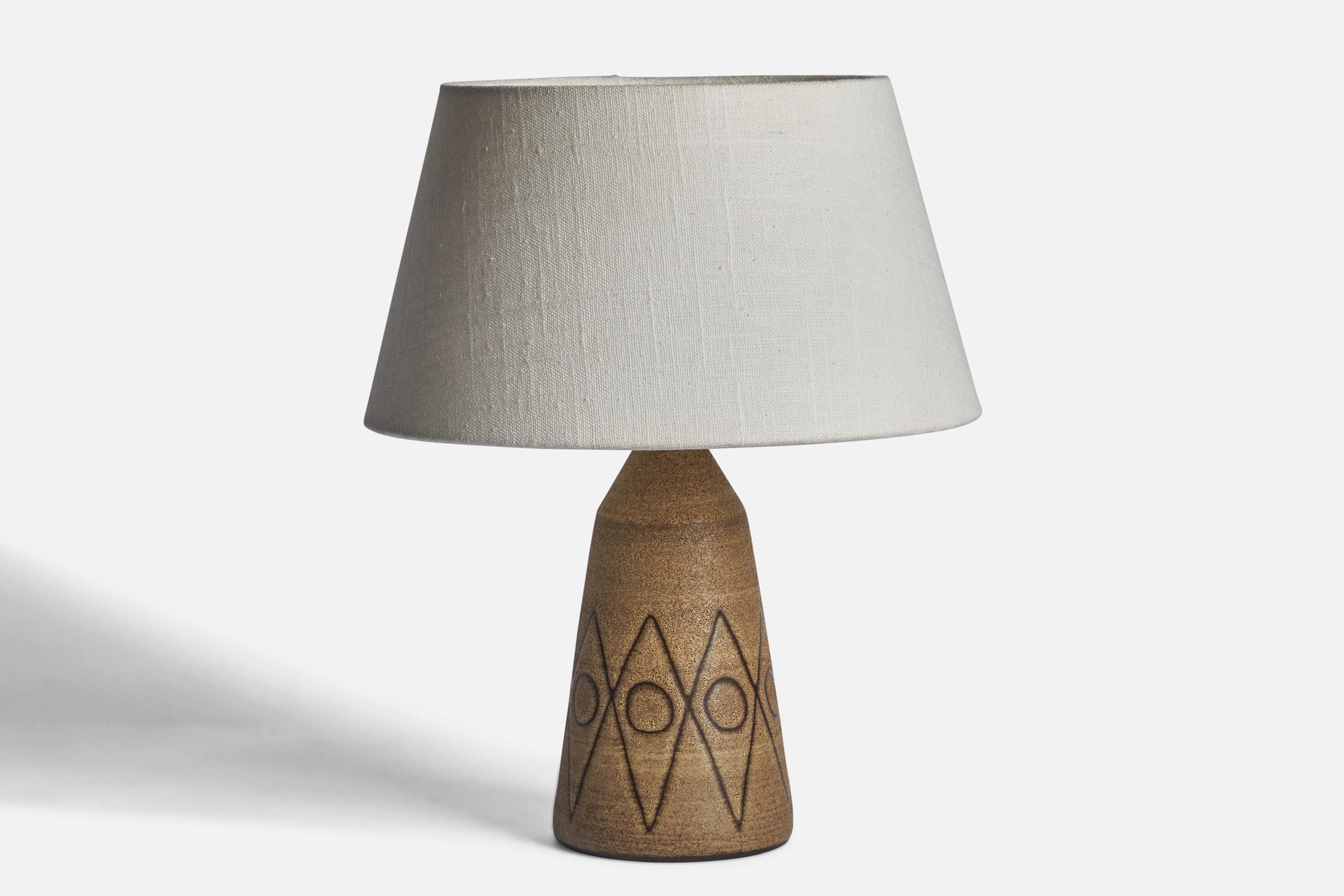A brown-glazed incised stoneware table lamp designed and produced in Sweden, 1960s.

Dimensions of Lamp (inches): 9.25” H x 4” Diameter
Dimensions of Shade (inches): 7” Top Diameter x 10” Bottom Diameter x 5.5” H 
Dimensions of Lamp with Shade
