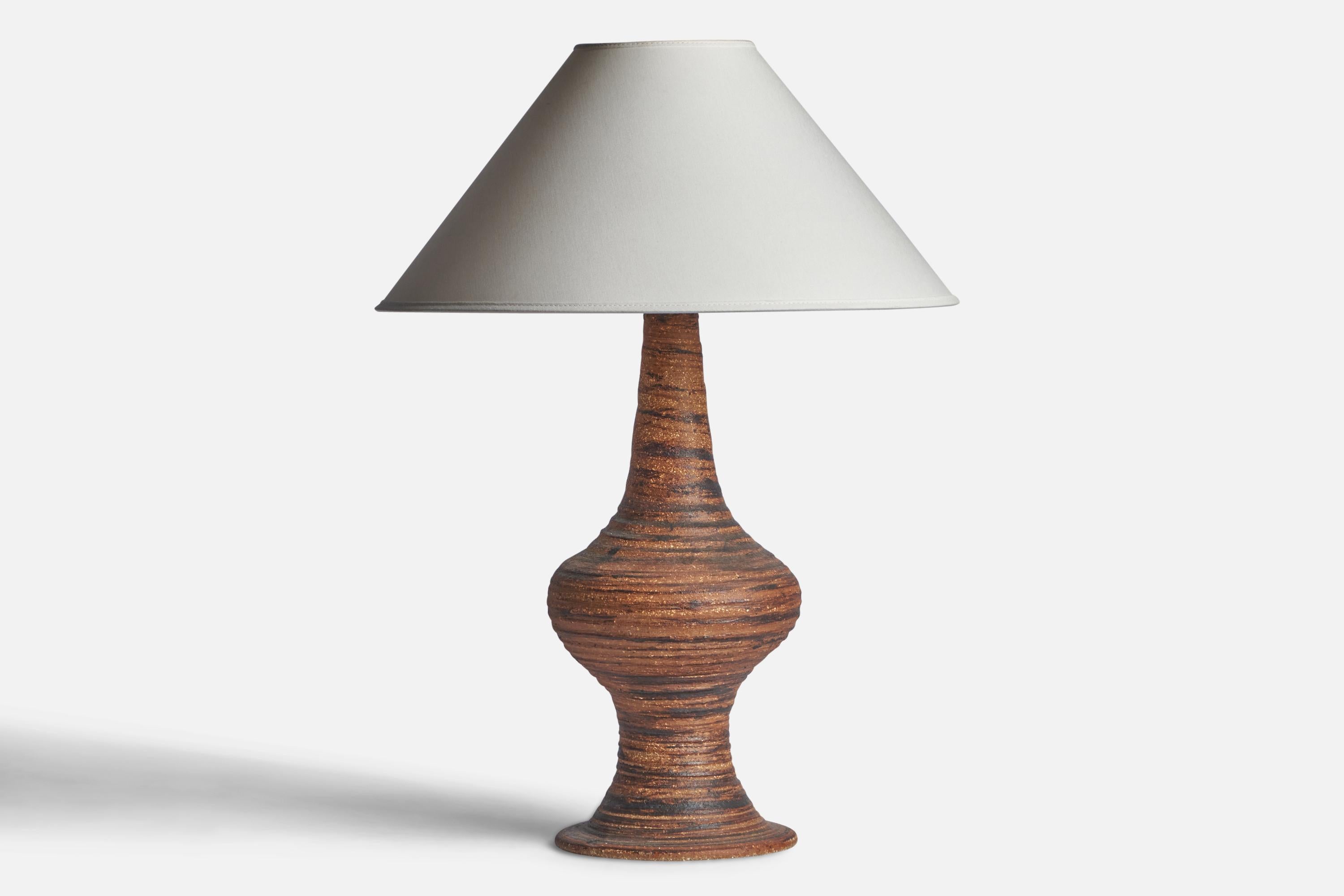A brown and black-glazed stoneware table lamp designed and produced in Sweden, c. 1960s.

Dimensions of Lamp (inches): 17.5” H x 6.95” Diameter
Dimensions of Shade (inches): 4.5” Top Diameter x 16” Bottom Diameter x 7.25” H
Dimensions of Lamp with