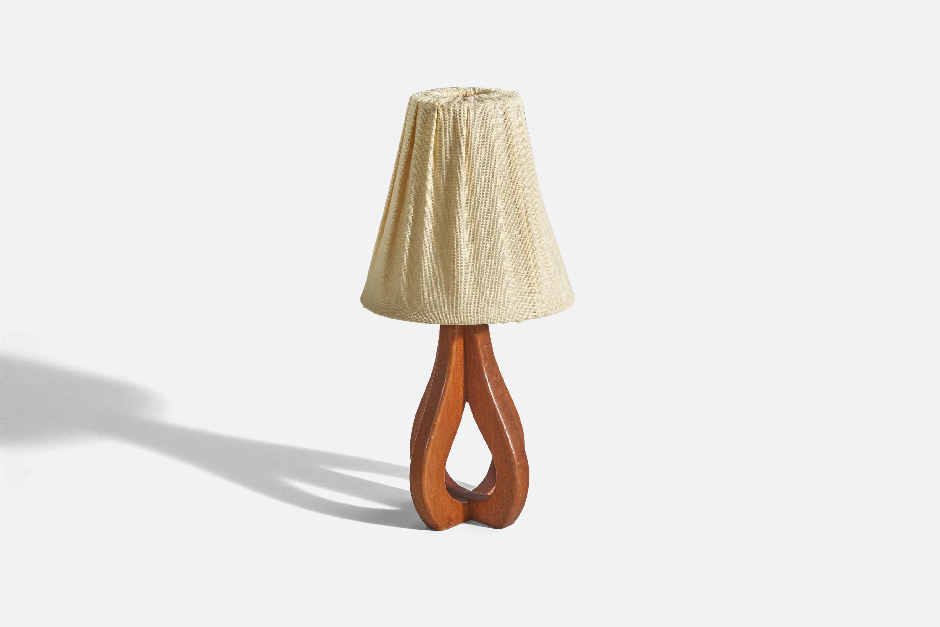 A teak and fabric table lamp designed and produced in Sweden, c. 1950s. 

Sold with lampshade. 
Dimensions of Lamp (inches) : 11.87 x 5.81 x 5.81 (height x width x depth)
Dimensions of Shade (inches) : 4 x 8 x 8 (top diameter x bottom diameter x
