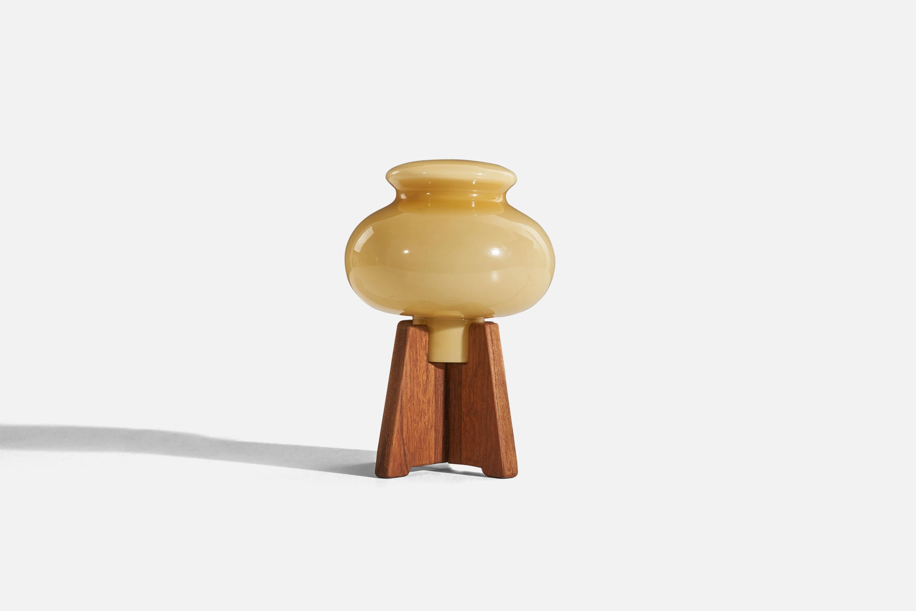 A teak and glass table lamp designed and produced in Sweden, c. 1960s. 

