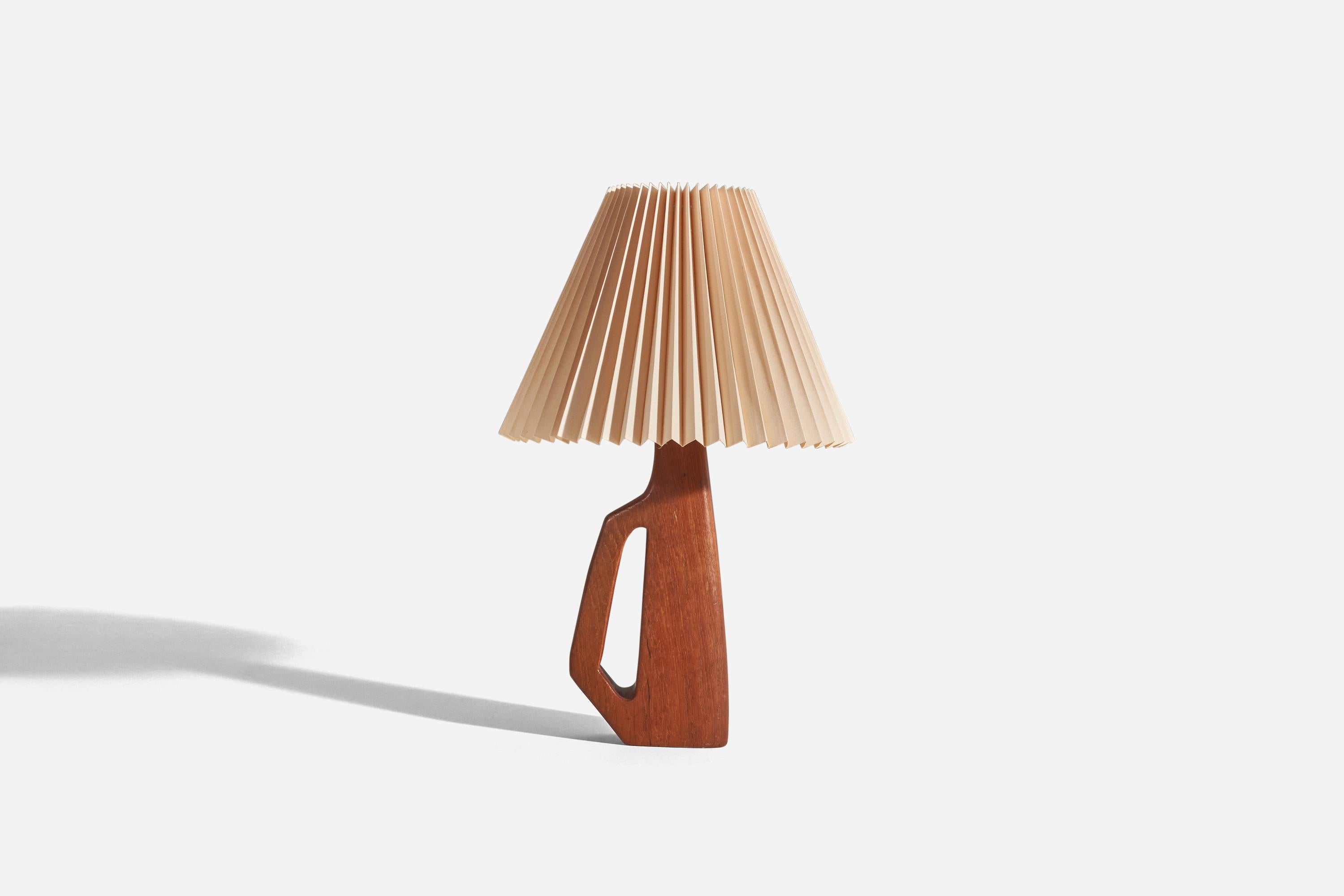 A teak and paper table lamp designed and produced in Sweden, c. 1960s.

Sold with lampshade. 
Dimensions of lamp (inches) : 11.75 x 5 x 2.72 (Height x Width x Depth)
Dimensions of shade (inches) : 4.62 x 11 x 8.25 (Top Diameter x Bottom Diameter