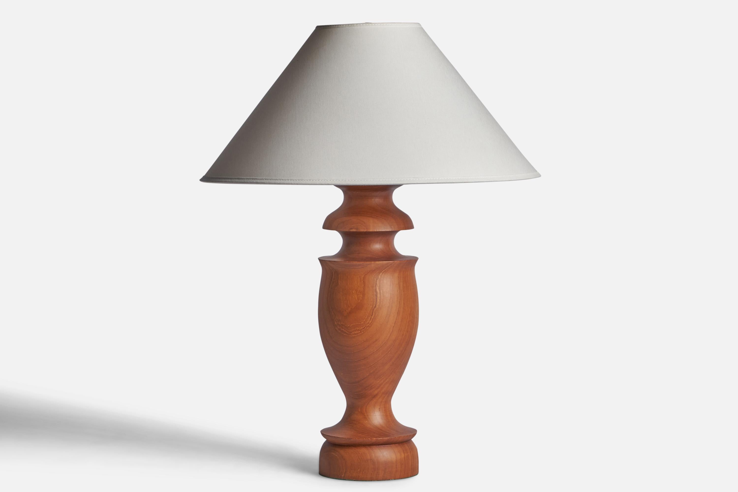 A teak table lamp designed and produced in Sweden, c. 1950s.

Dimensions of Lamp (inches): 16.95” H x 4.75” Diameter
Dimensions of Shade (inches): 4.5” Top Diameter x 16” Bottom Diameter x 7.25” H
Dimensions of Lamp with Shade (inches): 21.95” H x